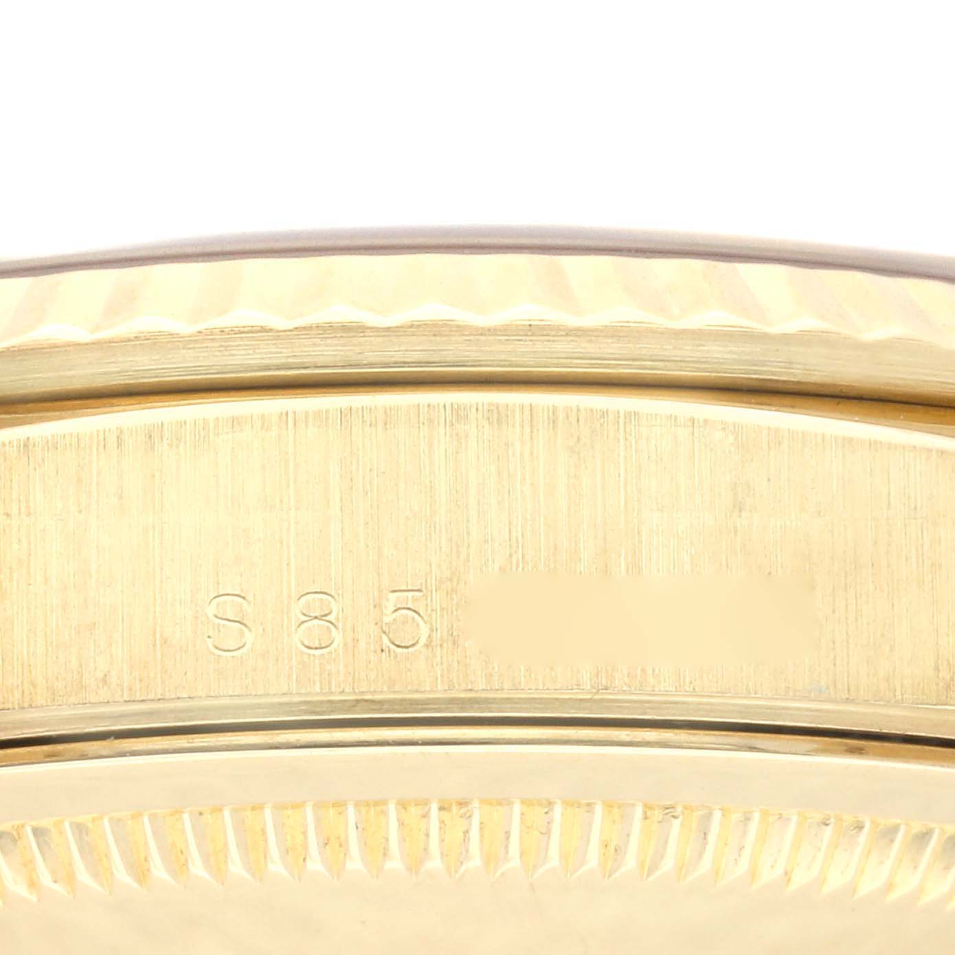 This image shows a close-up of the engraved serial number on the gold case back of a Rolex President 18238 Men's Yellow Gold Black Dial 18238 Men's Yellow Gold Black Dial model watch.