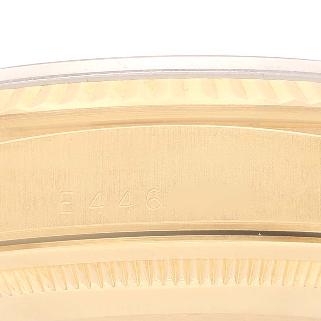 This image shows the engraving and part of the gold bezel of the Rolex President 18238 Men
s Yellow Gold Champagne Dial 18238 Men
s Yellow Gold Champagne Dial watch model.