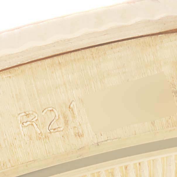 This close-up image shows part of the inside of the bezel and engraved markings on a Rolex President 67198 Women
s Yellow Gold Champagne Dial 67198 Women
s Yellow Gold Champagne Dial model watch.