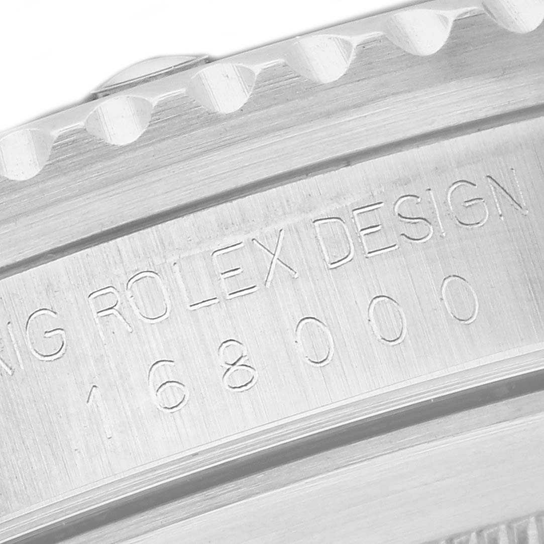 This image shows a close-up of the side engraving and bezel teeth of a Rolex Vintage Collection 168000 Men's Stainless Steel Black Dial 168000 Men's Stainless Steel Black Dial model watch.