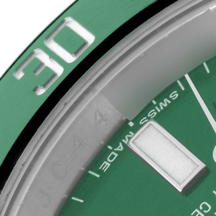This close-up image shows a portion of the green bezel and dial of a Rolex Submariner 116610LV Men's Stainless Steel Green Dial 116610LV Men's Stainless Steel Green Dial watch.