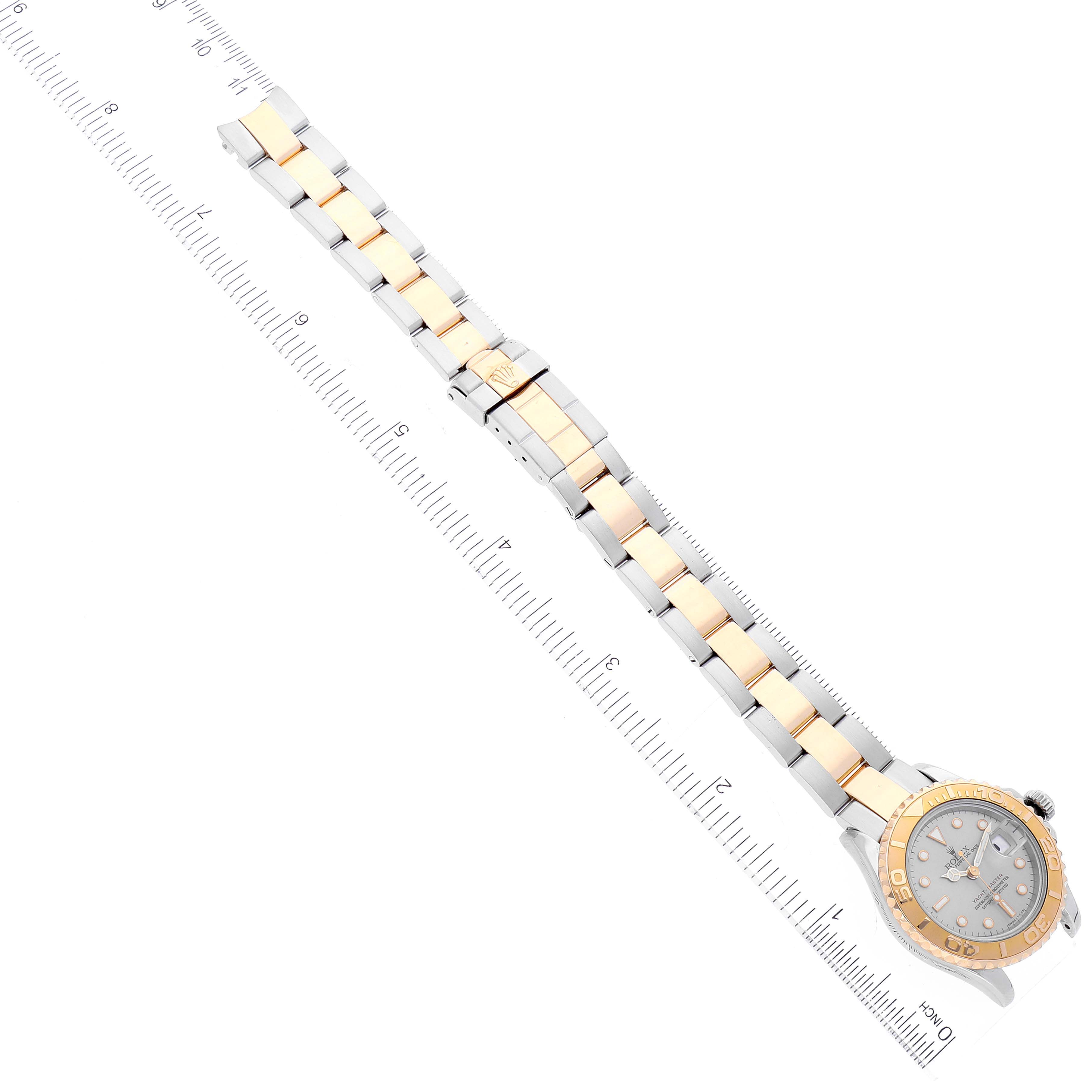 The Yacht-Master model by Rolex is shown in a flat, fully extended position, including the face, bezel, and bracelet.