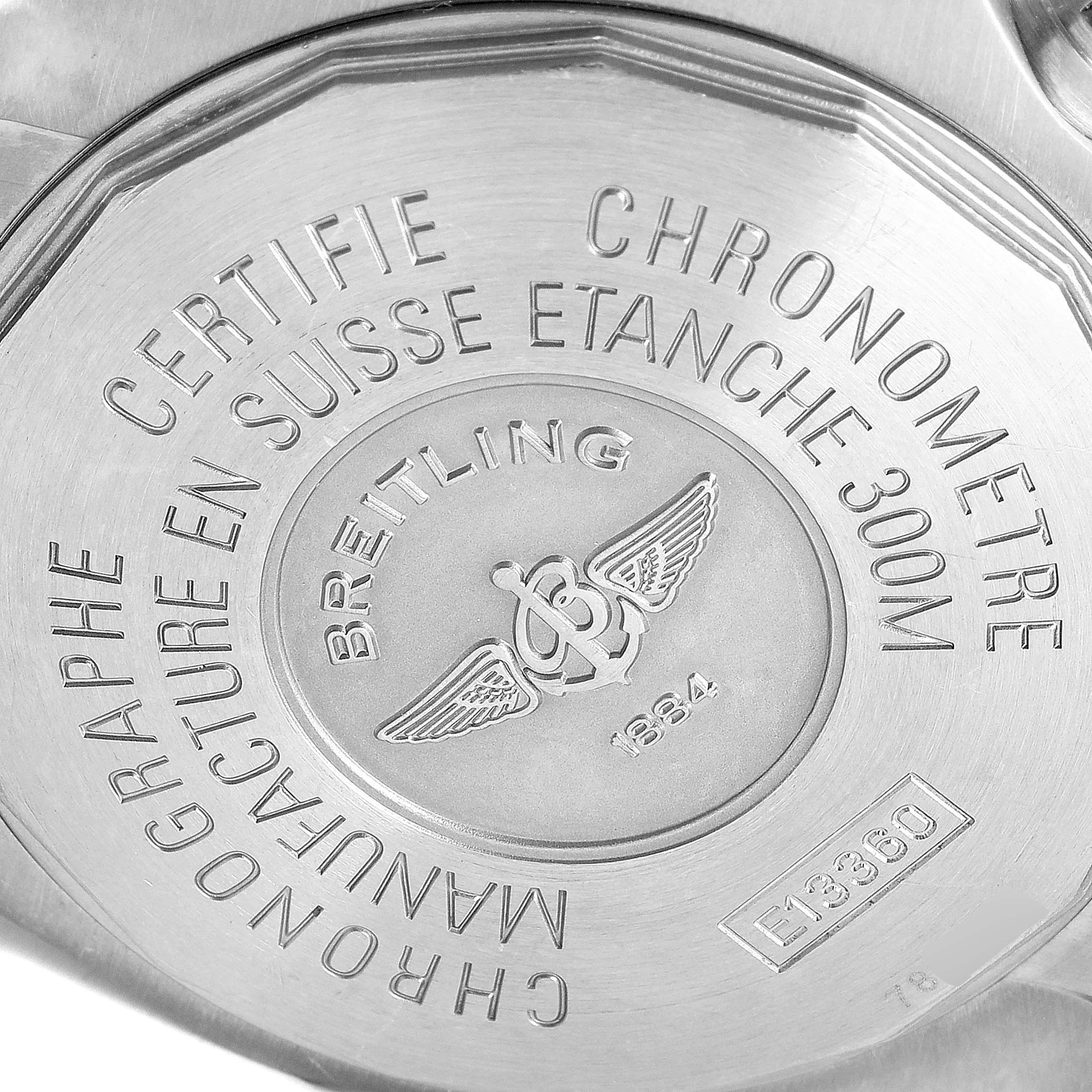 The image shows the back case of the Breitling Avenger E13360 Men's Titanium Black Dial E13360 Men's Titanium Black Dial watch, displaying its engravings and logo.