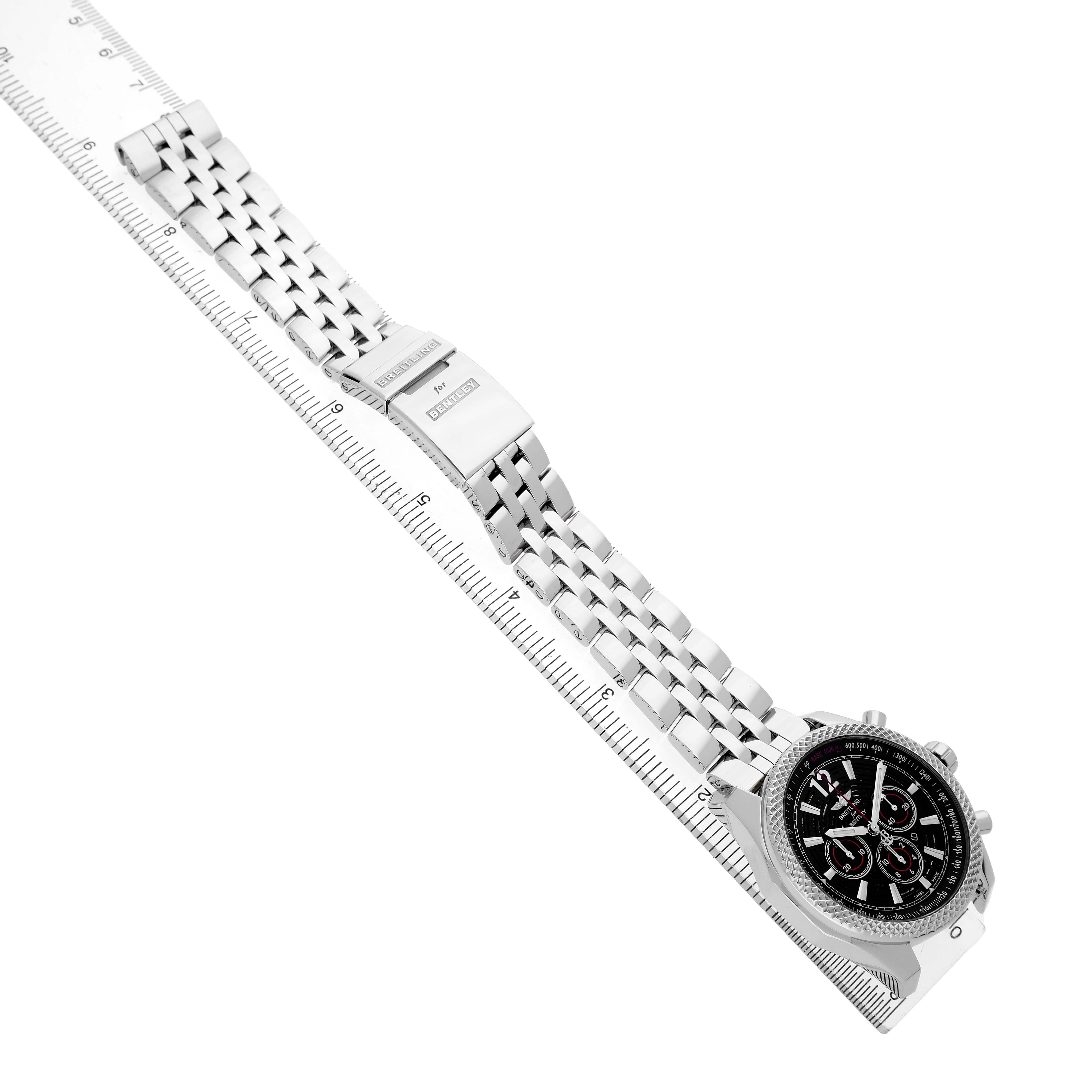 The Breitling Bentley A41390 Men's Stainless Steel Black Dial watch is shown at an angle, displaying the case, dial, and full stainless steel bracelet alongside a ruler for scale.