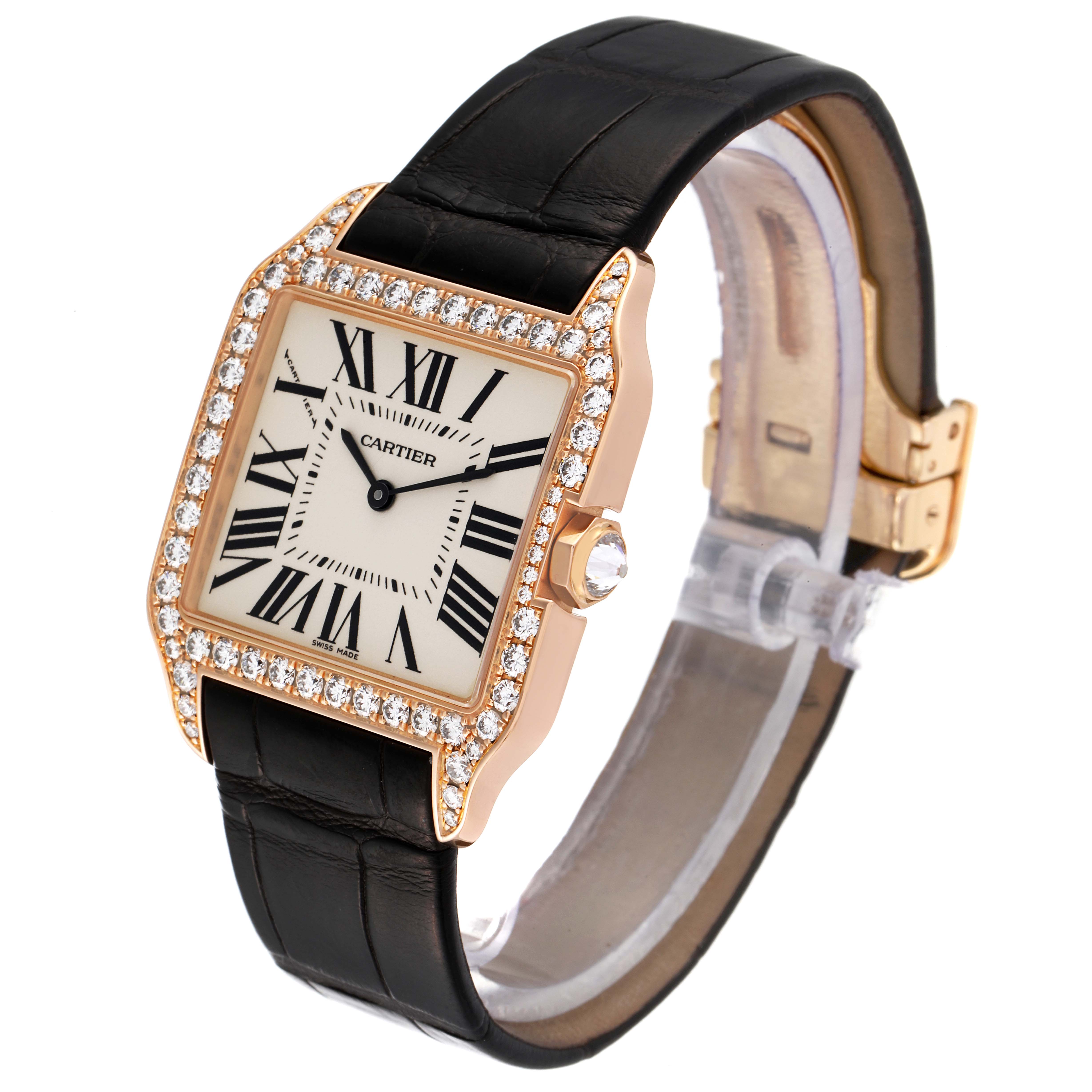 The image shows a Cartier Santos Dumont WH100351 Men's Rose Gold Silver Dial WH100351 Men's Rose Gold Silver Dial watch from an angled perspective, highlighting its diamond bezel, black strap, and rectangular face.