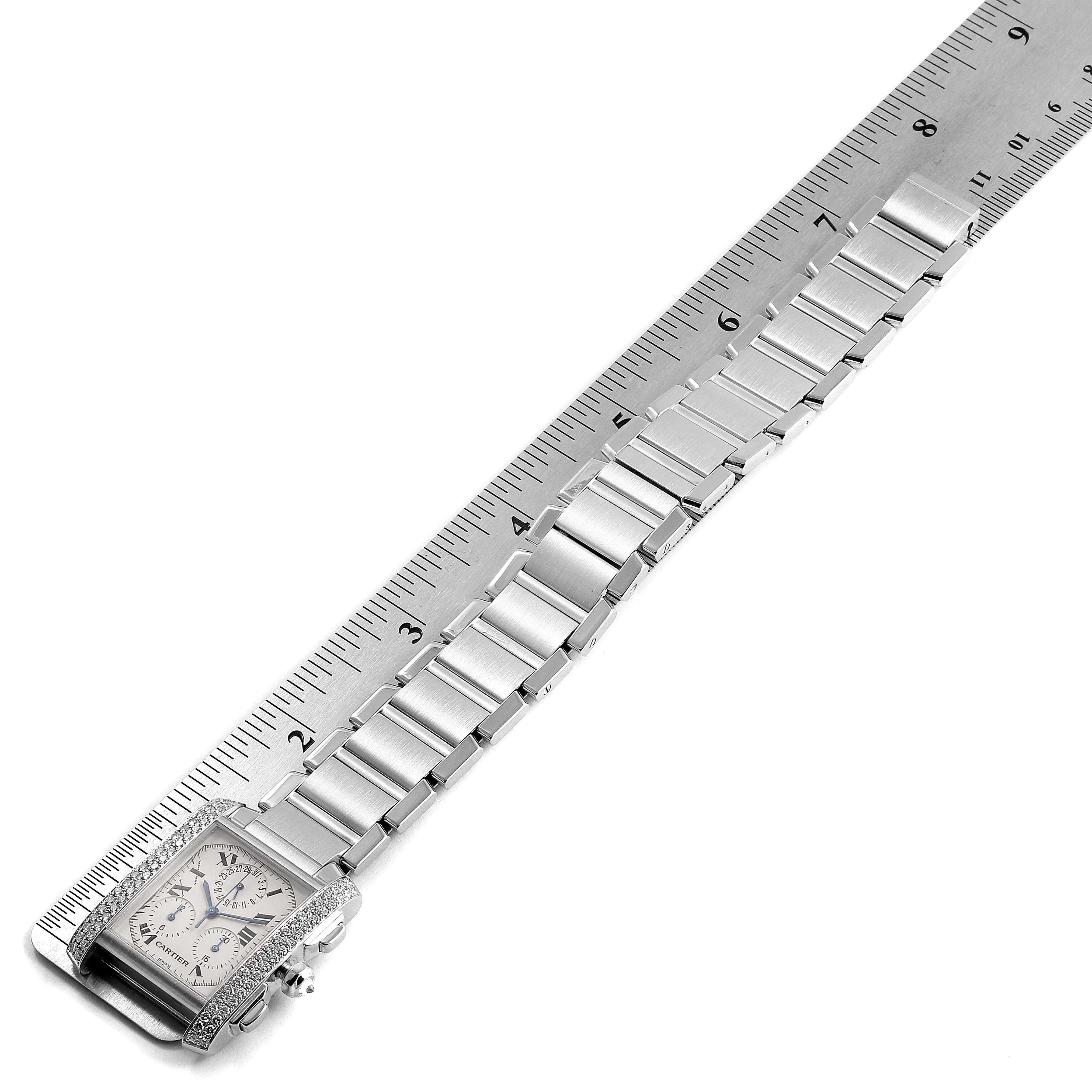 The image shows a Cartier Tank Française watch laid flat next to a ruler, revealing the case, dial, and part of the metal bracelet.