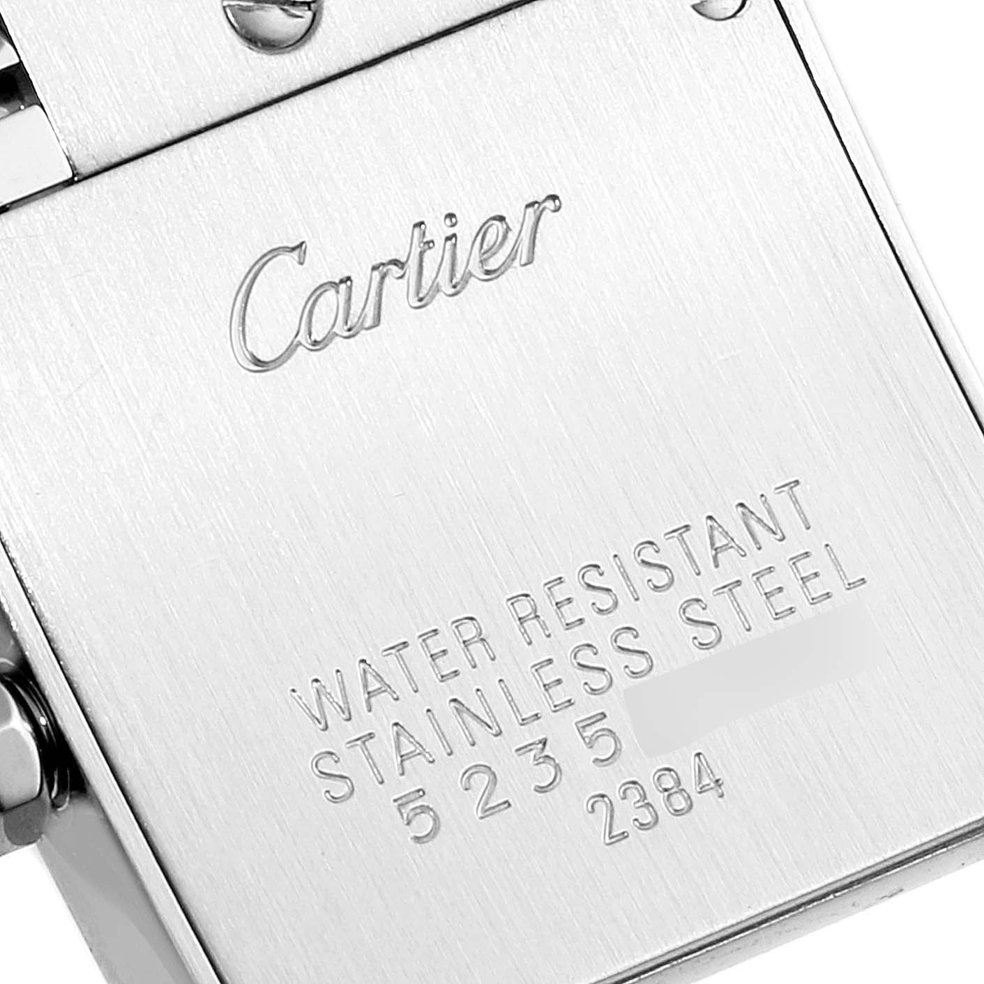 The image shows the case back of the Tank Française watch by Cartier with engraved details.