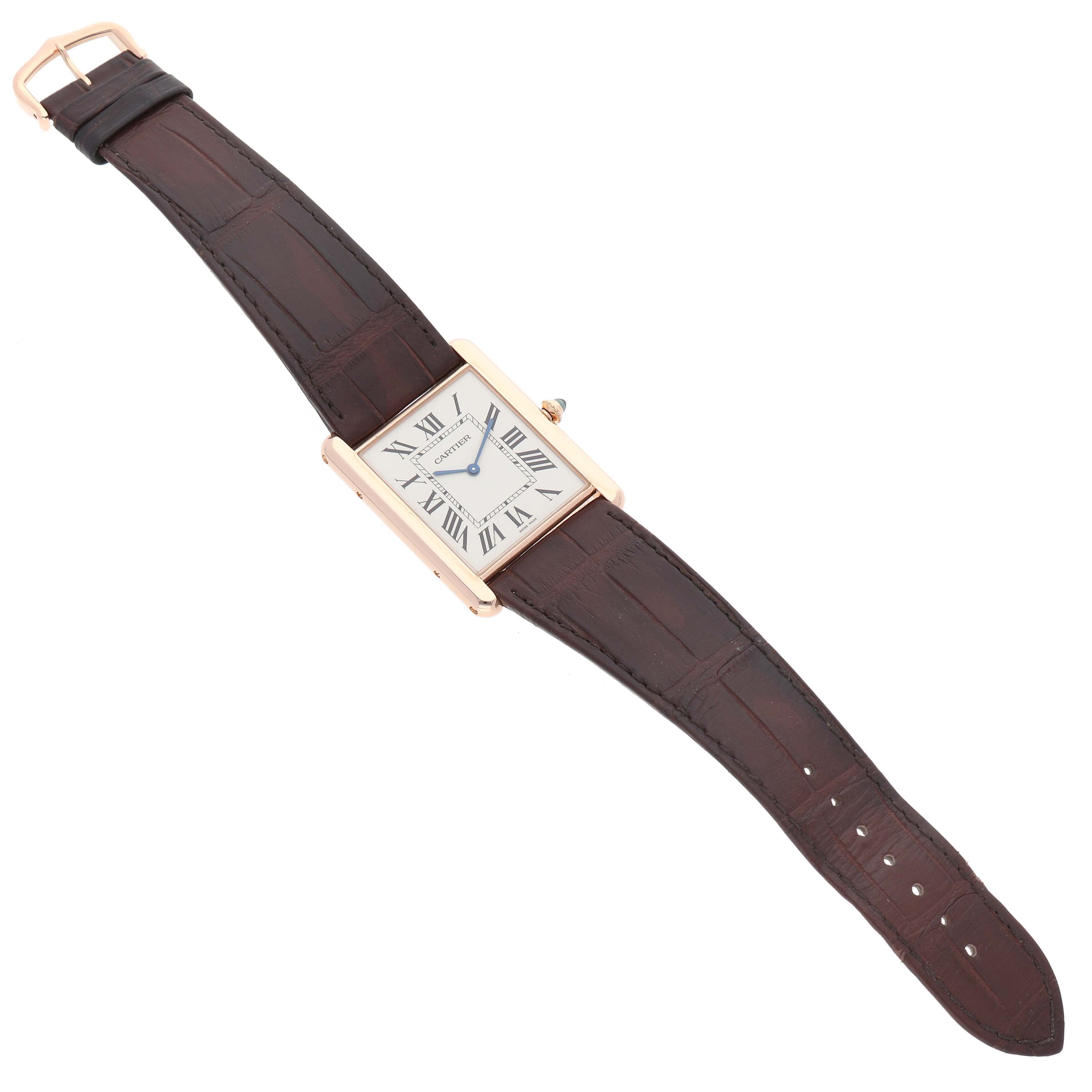 The Cartier Tank Louis W1560017 Men's Rose Gold Silver Dial watch is shown from an angled top-down view, highlighting the face, case, and strap.