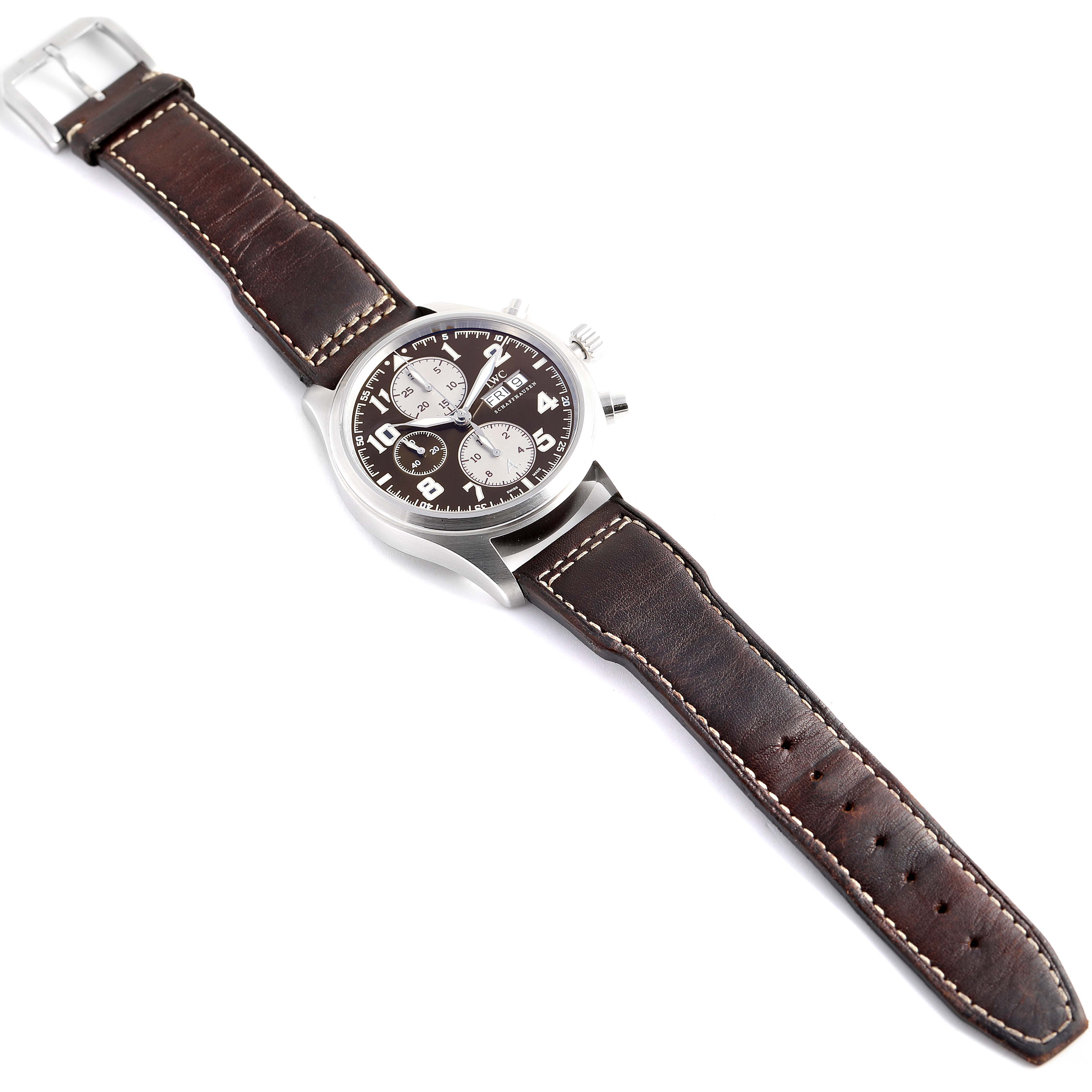 This image shows an IWC Pilot IW371709 Men's Stainless Steel Brown Dial IW371709 Men's Stainless Steel Brown Dial model watch laid flat, displaying its brown leather strap, stainless steel case, and face.