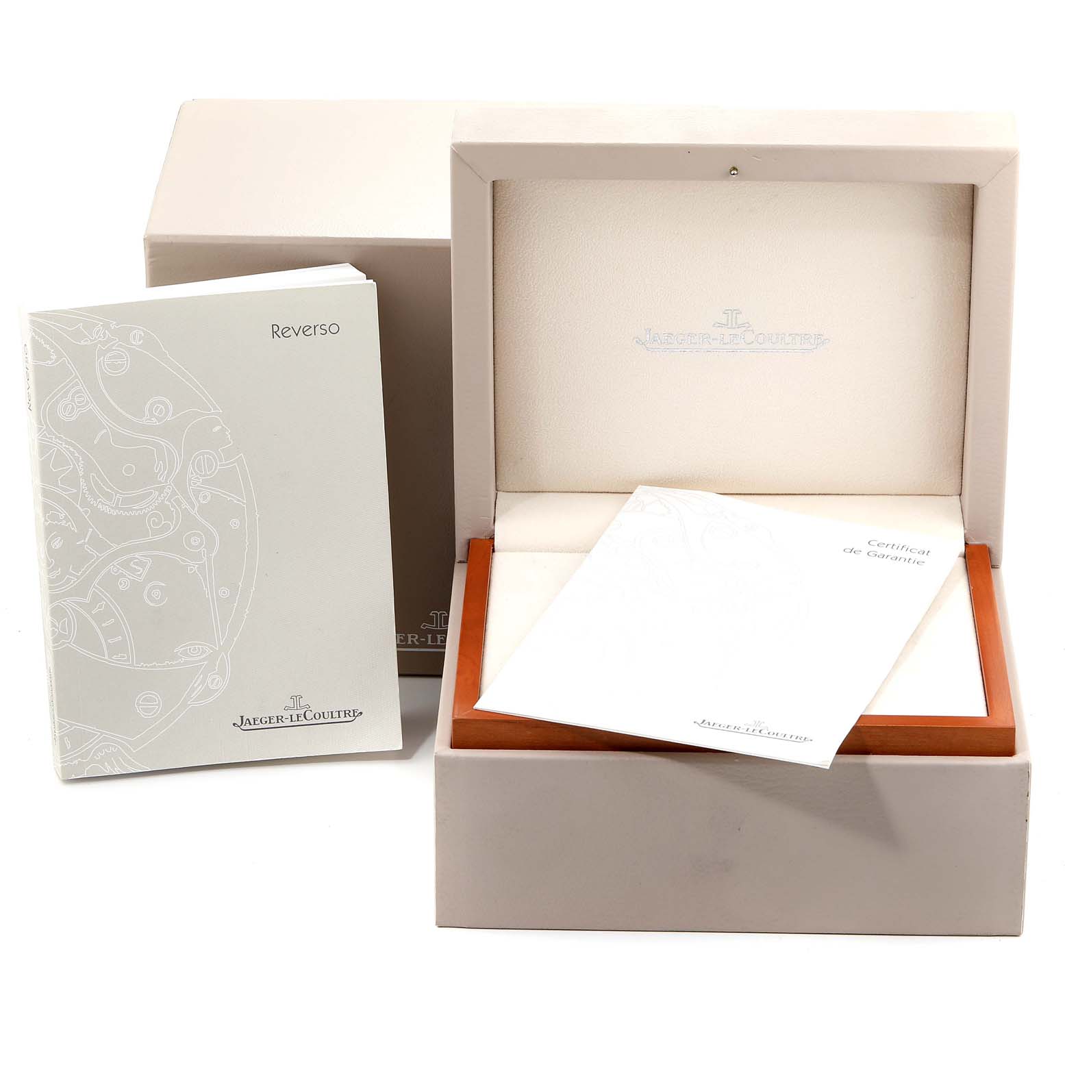 The image shows the box, booklet, and warranty card for a Jaeger-LeCoultre Reverso model watch.
