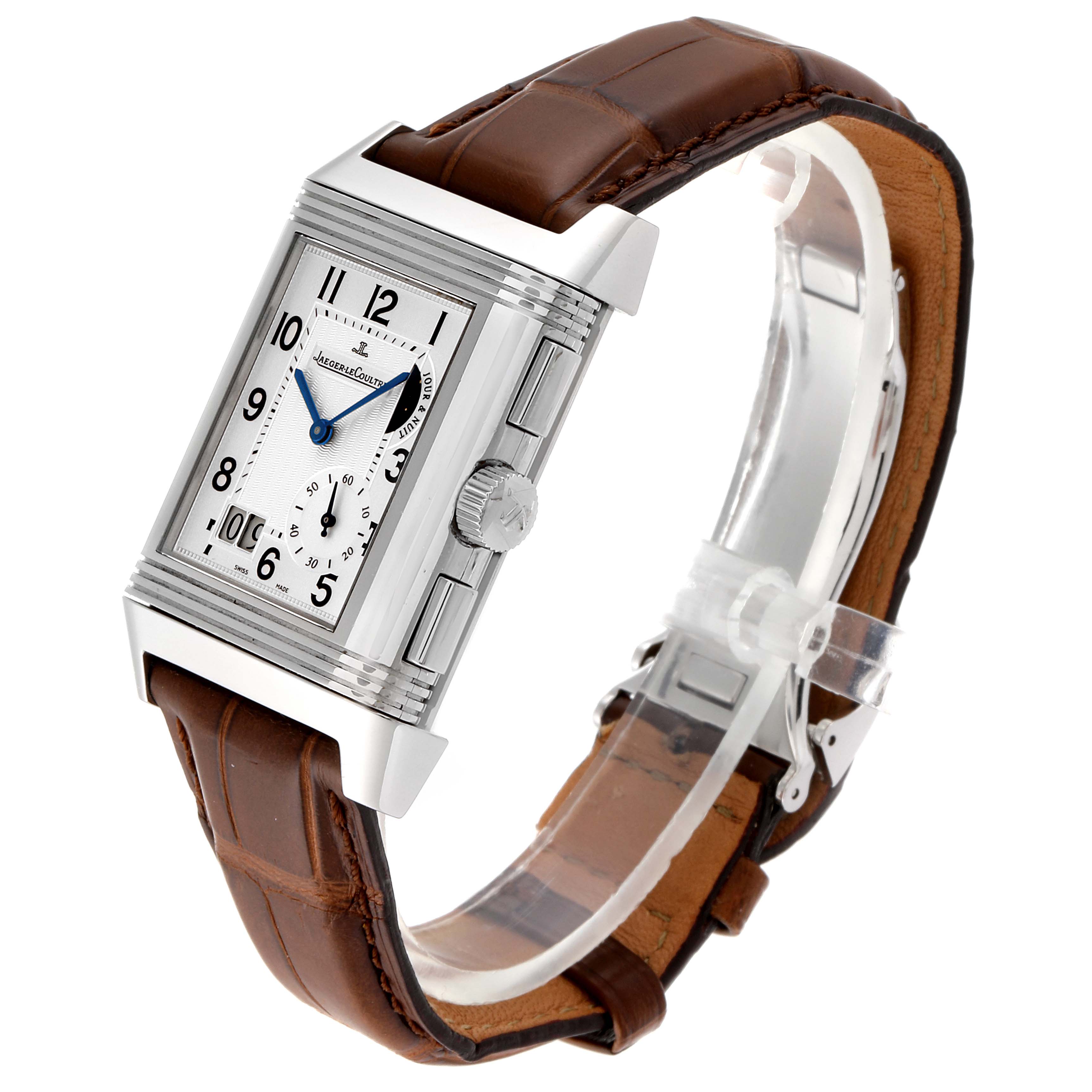 The image shows a Jaeger-LeCoultre Reverso watch at a three-quarter angle, displaying its rectangular case, dial, crown, and brown leather strap.