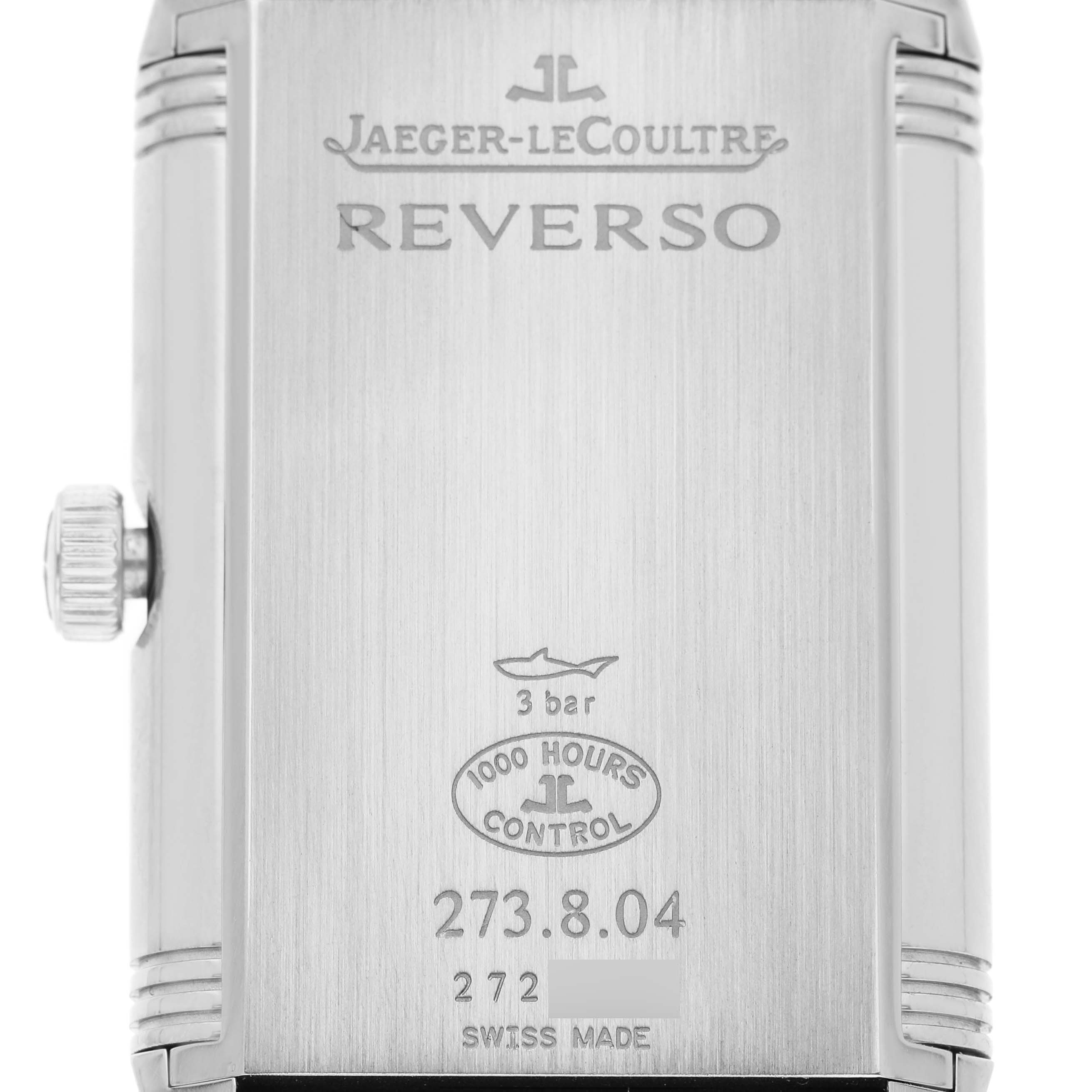 The image shows the case back of a Jaeger-LeCoultre Reverso watch, highlighting the brand, model name, and technical details.