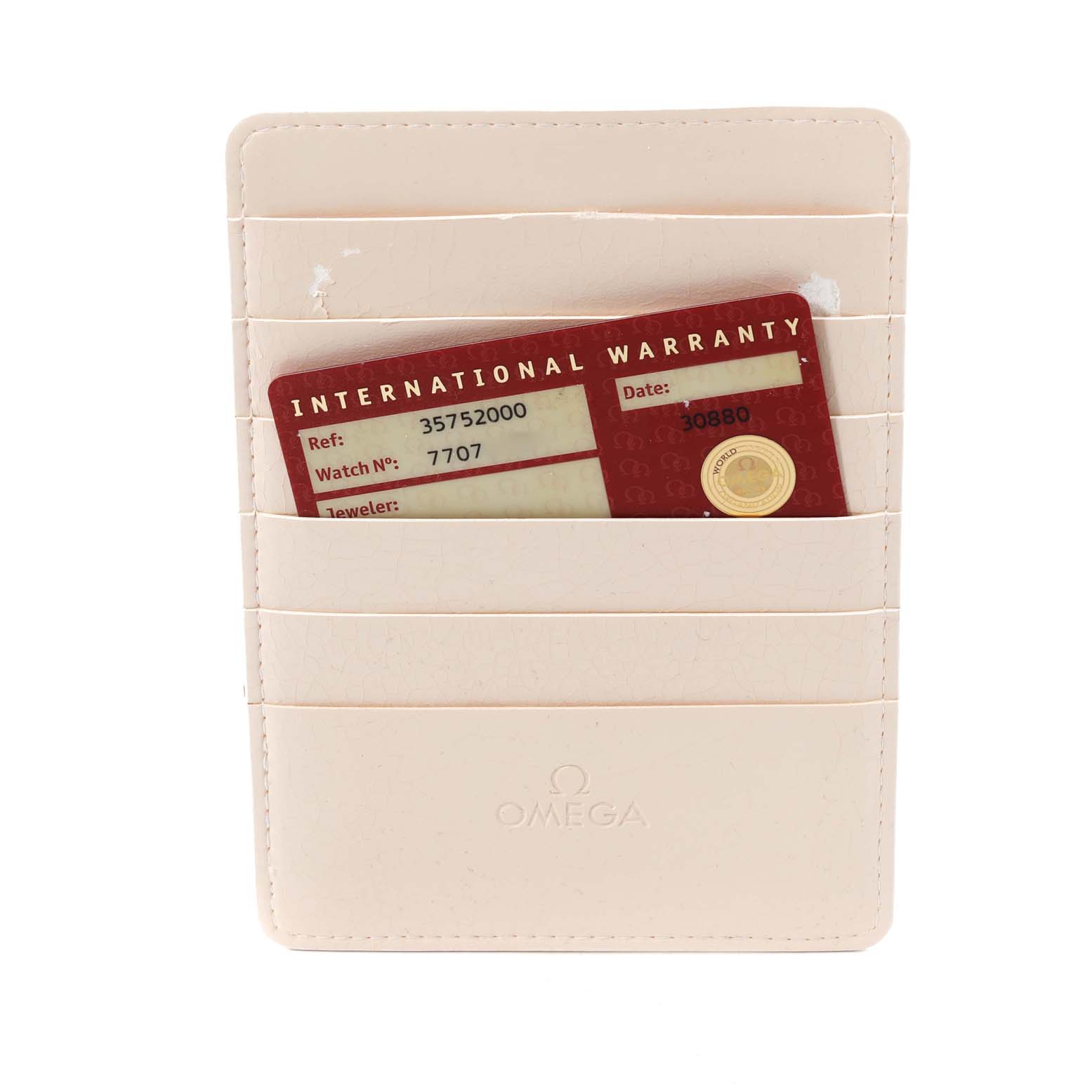 The image shows an Omega Speedmaster 3575.20.00 Men's Stainless Steel White Dial 3575.20.00 Men's Stainless Steel White Dial's International Warranty Card inside a beige cardholder.