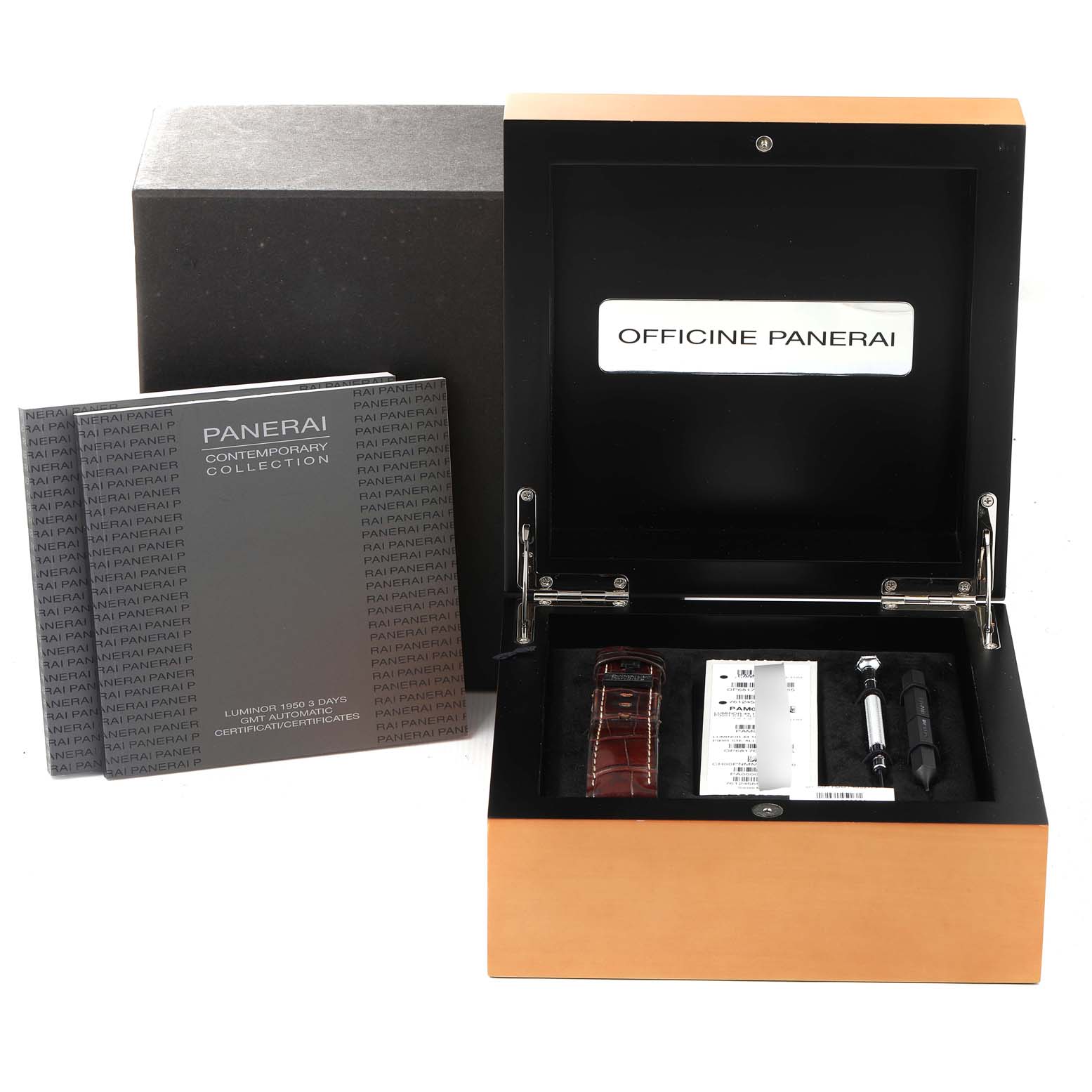 The image shows the packaging of a Panerai Luminor PAM00320 Men
s Stainless Steel Black Dial PAM00320 Men
s Stainless Steel Black Dial model, including a box, manuals, a strap, and tools.