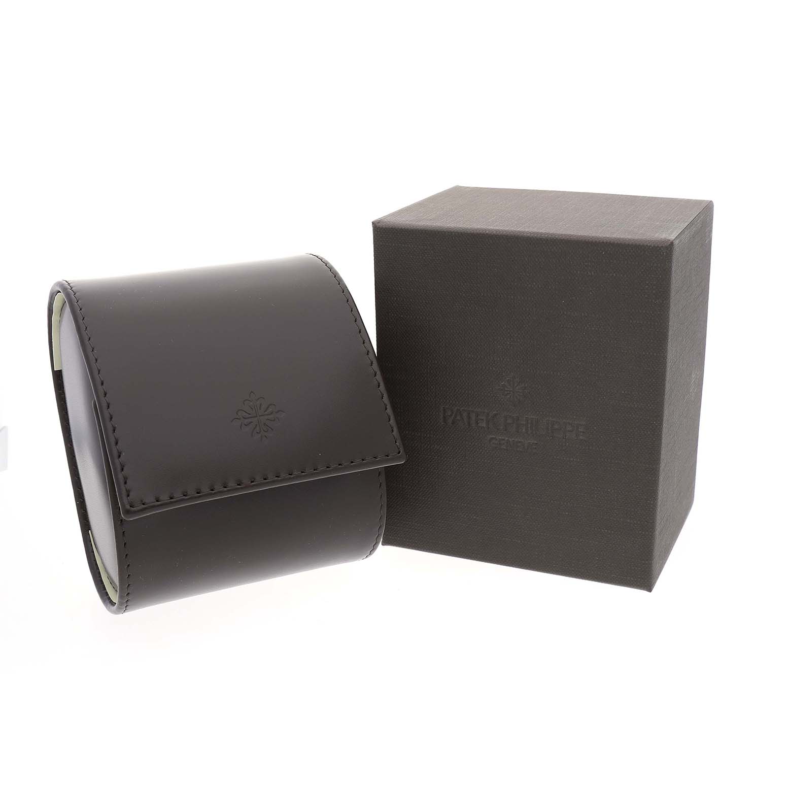 The image shows a Patek Philippe Calatrava 83323 Men's White Gold White Dial watch box and a leather pouch, angled slightly to the right.