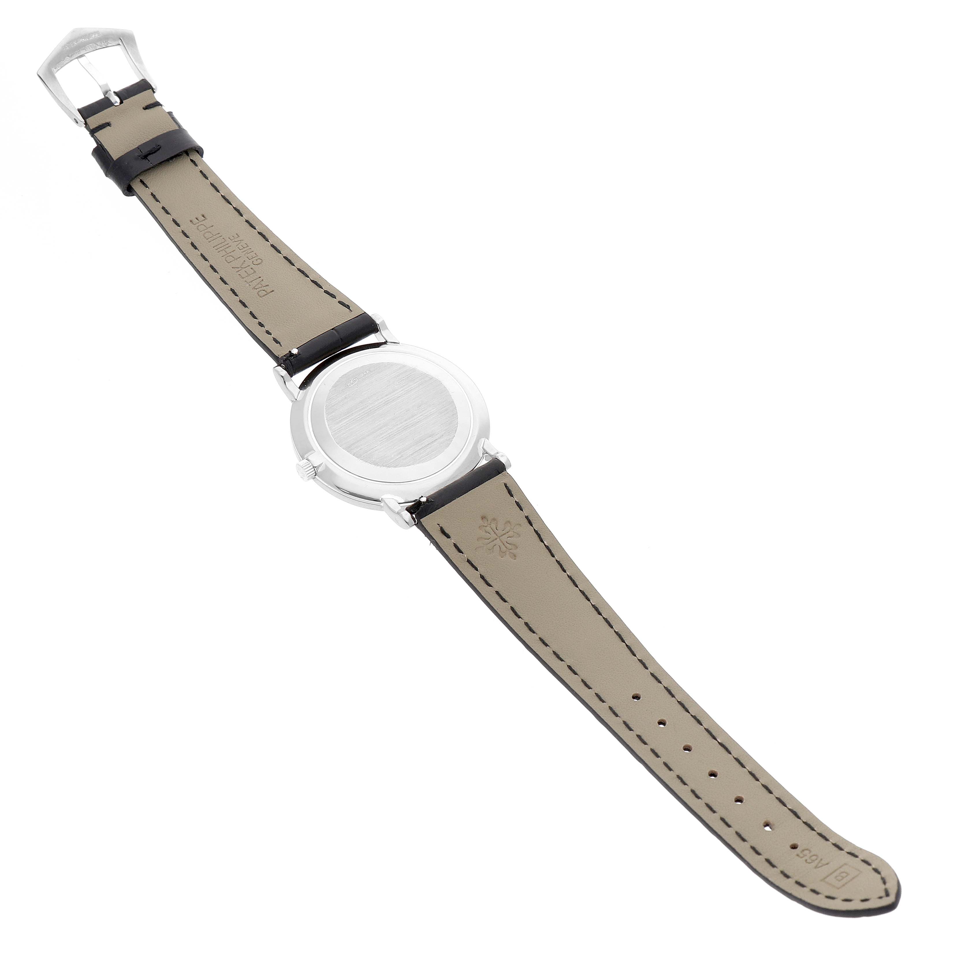 The Patek Philippe Calatrava 83323 Men's White Gold White Dial watch is shown from the back, displaying the case back and the leather strap with buckle.