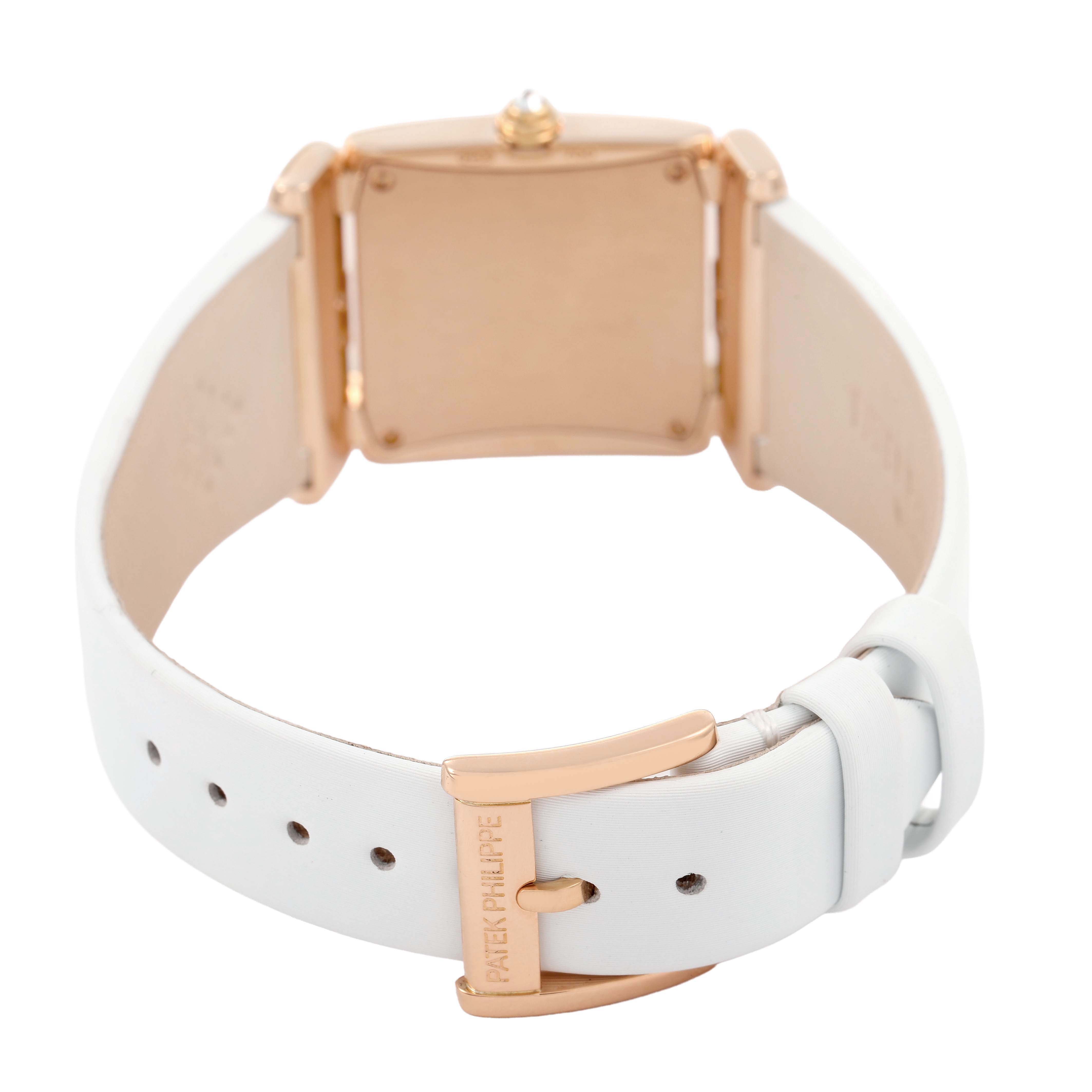 The Patek Philippe Twenty-4 4920R-010 Women's Rose Gold Silver Dial watch is shown from behind, displaying the back case and the buckle of the white strap.