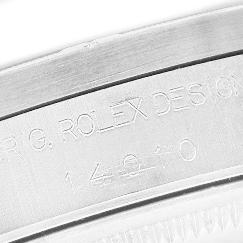 The image shows a close-up of the engraved side of a Rolex Air-King 14010 Men's Stainless Steel Black Dial watch case, highlighting the design and model number.