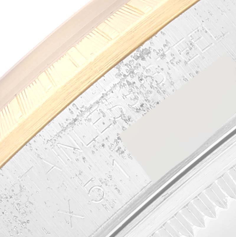 This is a close-up angle showing the side of a Rolex Date 15223 Men's Steel and Gold (two tone) Blue Dial 15223 Men's Steel and Gold (two tone) Blue Dial model watch with visible engravings.