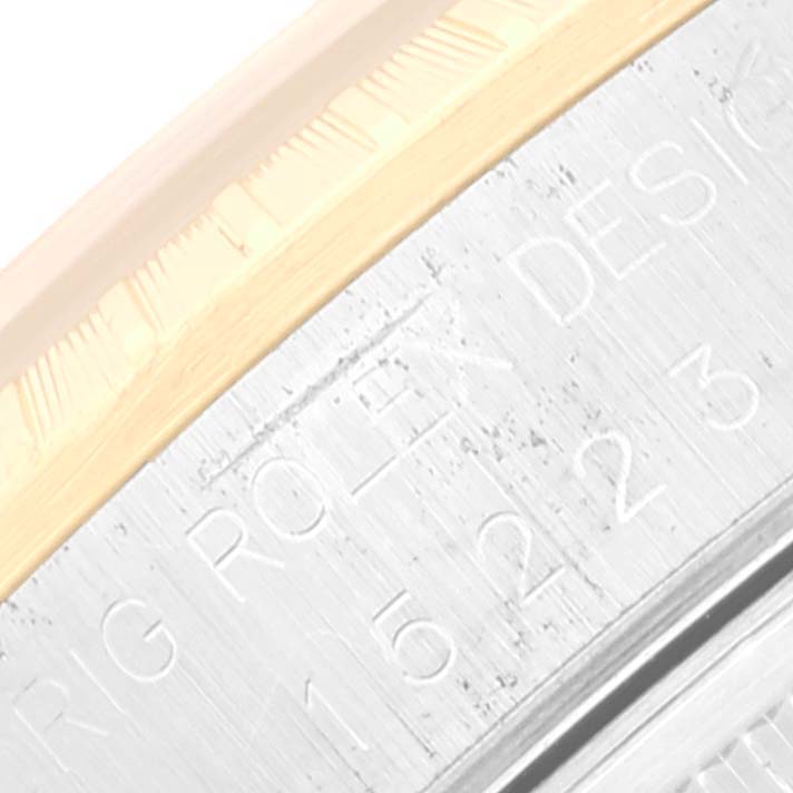 This image shows a close-up angle of the side engraving on a Rolex Date 15223 Men's Steel and Gold (two tone) Blue Dial 15223 Men's Steel and Gold (two tone) Blue Dial model watch.
