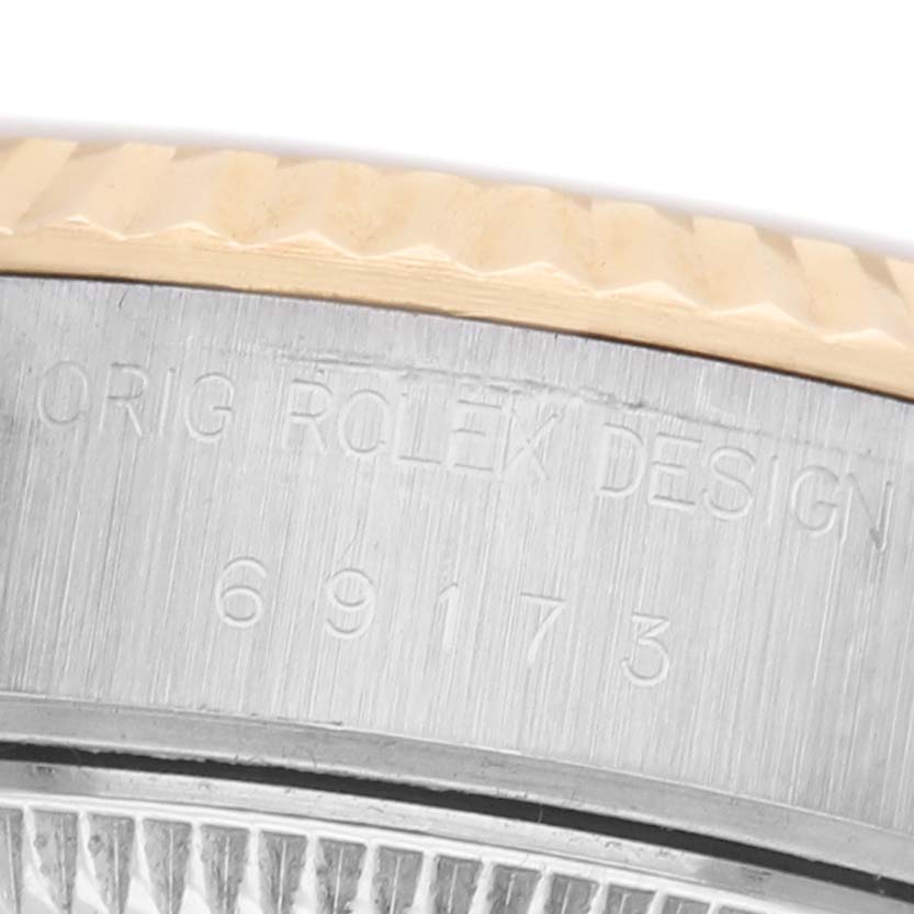 The image shows a close-up of the Rolex Datejust 69173 Women's Stainless Steel Champagne Dial model's side, highlighting the fluted bezel and engraved model number.