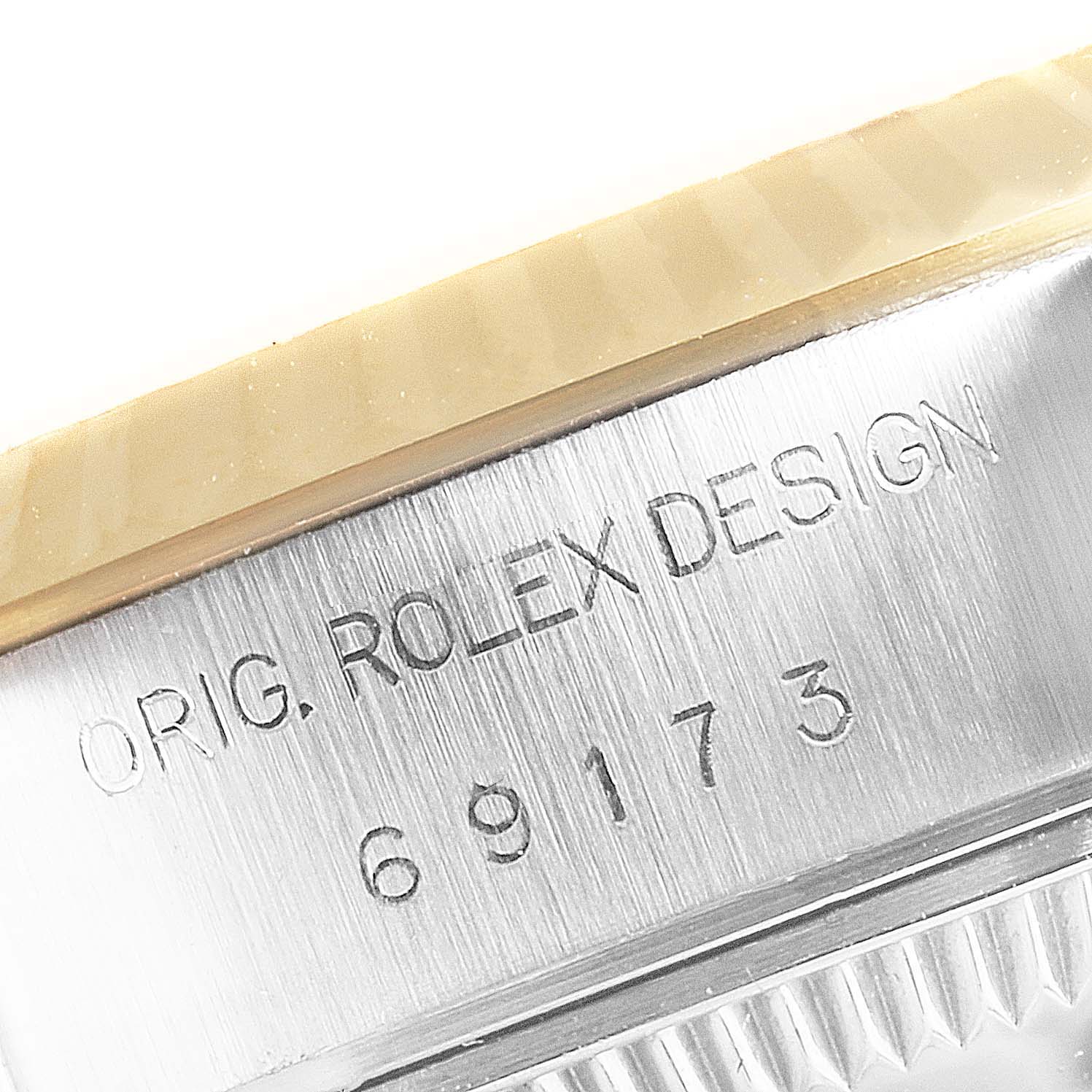 The image shows a close-up of the engraved serial number and "ORIG. ROLEX DESIGN" on the case side of a Rolex Datejust 69173 Women's Steel and Gold (two tone) Black Dial 69173 Women's Steel and Gold (two tone) Black Dial watch.