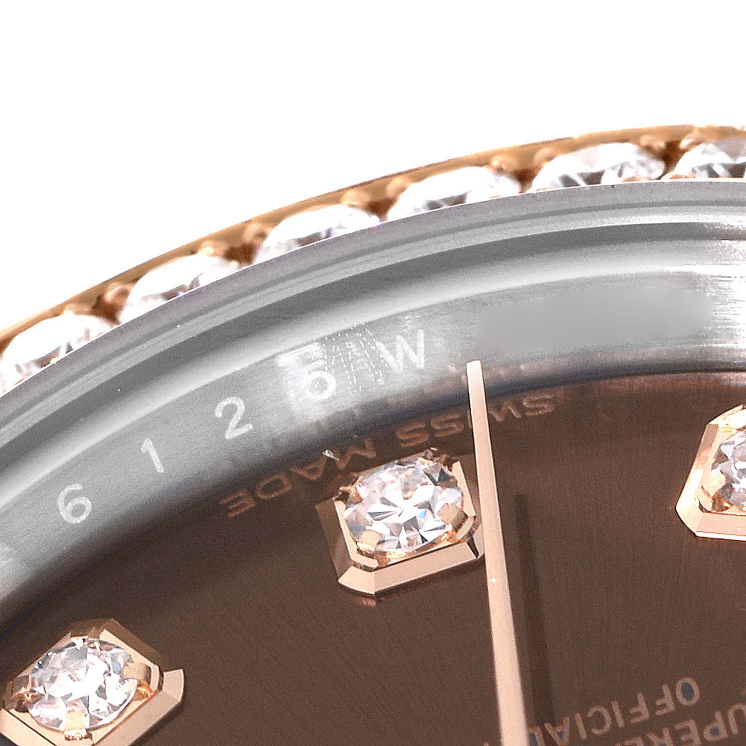 This close-up angle of the Rolex Datejust 279381 Women's Steel and Gold (two tone) Brown Dial 279381 Women's Steel and Gold (two tone) Brown Dial watch shows the dial with diamond markers and a portion of the bezel decorated with gemstones.