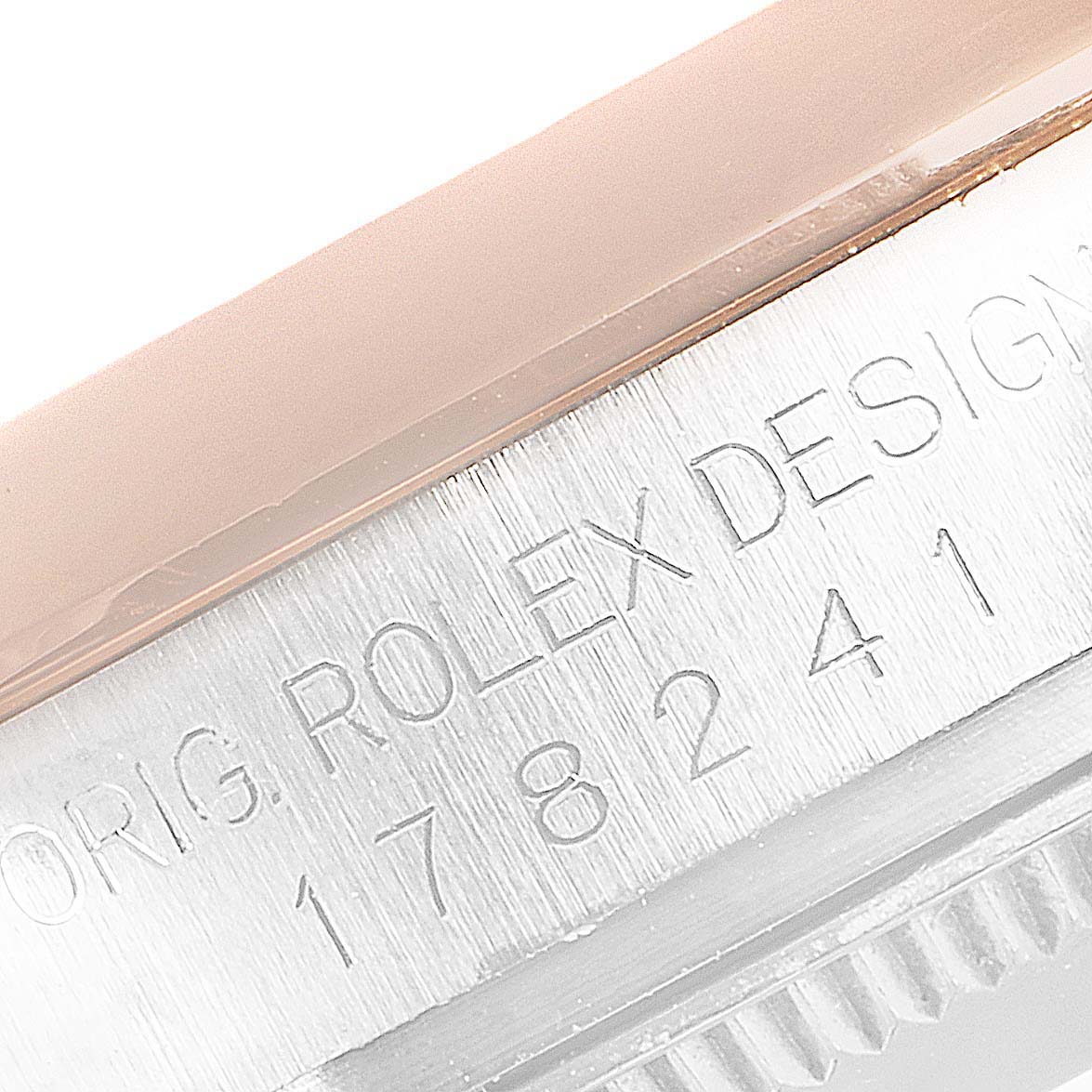 This close-up image shows the engraved text on the side of the Mid-Size Rolex watch case.