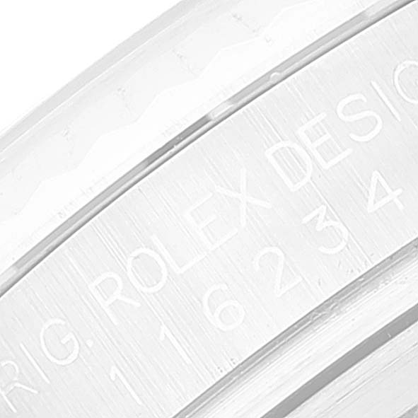 This close-up image of a Rolex Datejust 116234 Men's Stainless Steel Mother of Pearl Dial 116234 Men's Stainless Steel Mother of Pearl Dial watch shows the engraved inner bezel with model details.