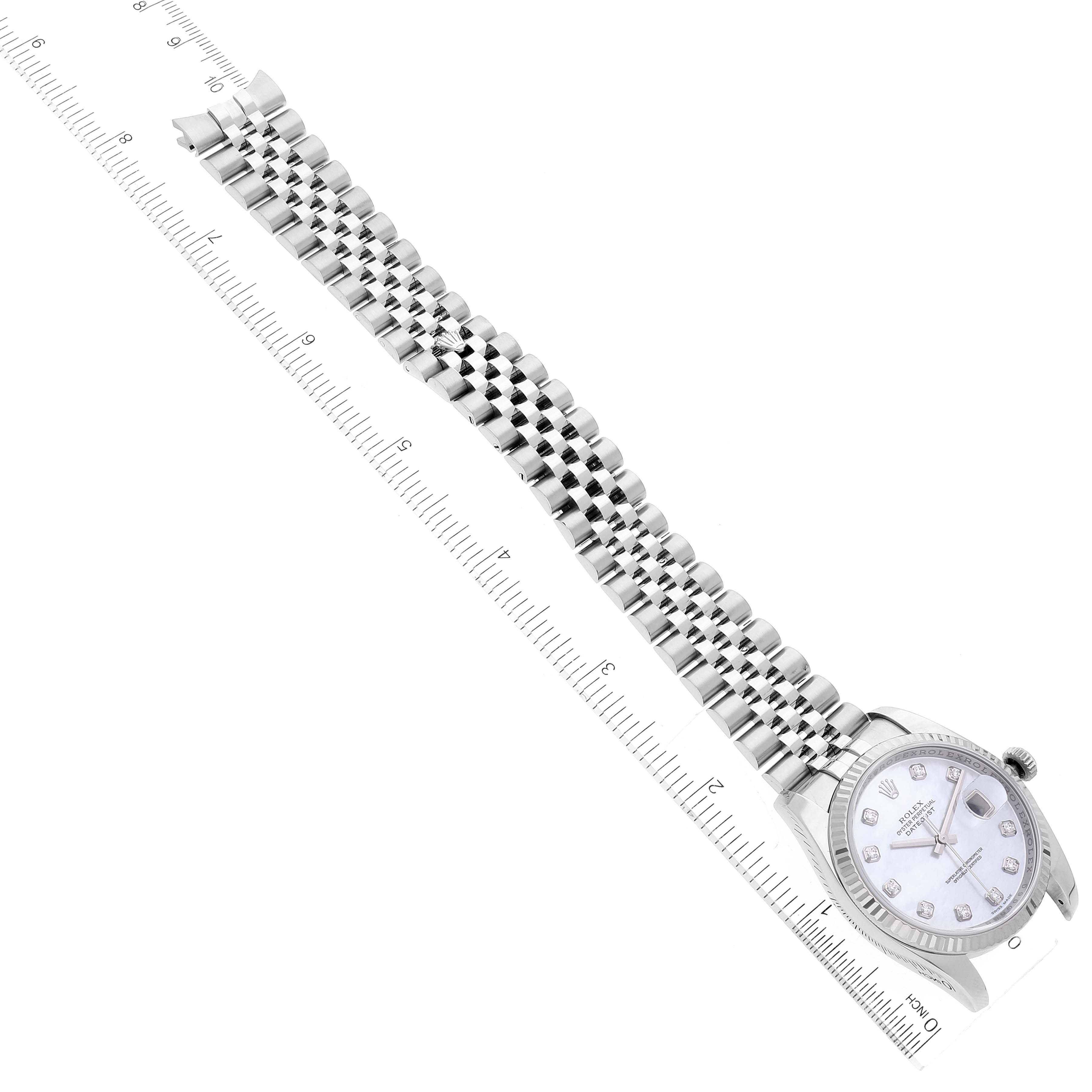 The image shows a top-down view of a Rolex Datejust 116234 Men's Stainless Steel Mother of Pearl Dial 116234 Men's Stainless Steel Mother of Pearl Dial watch, highlighting its bracelet and face next to a ruler for scale.
