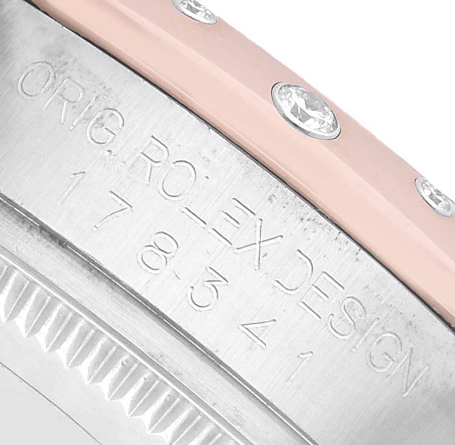 The image shows a close-up side view of the Rolex Datejust 178341 Women's Steel and Gold (two tone) Black Dial watch case with engravings and part of the bezel with diamonds.