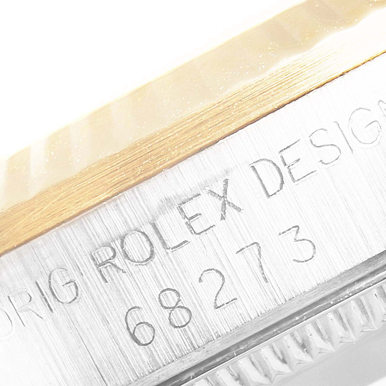 This close-up image shows the serial number engraving on the side of a Mid-Size Rolex watch case.