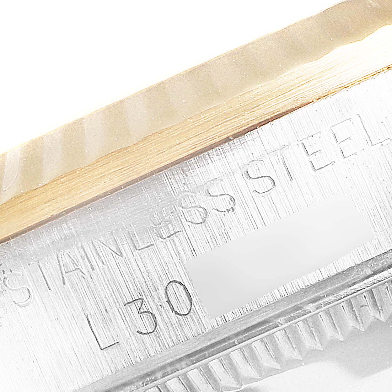 The image shows a close-up of the side of a Rolex Mid-Size 68273 Women
s Steel and Gold (two tone) Champagne Dial 68273 Women
s Steel and Gold (two tone) Champagne Dial watch, featuring the stainless steel band and part of the bezel.