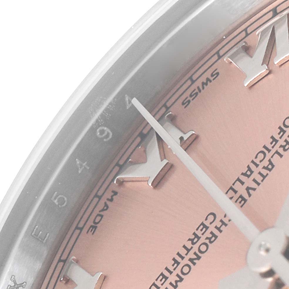 This close-up image shows the dial and hour markers of a Mid-Size Rolex watch.