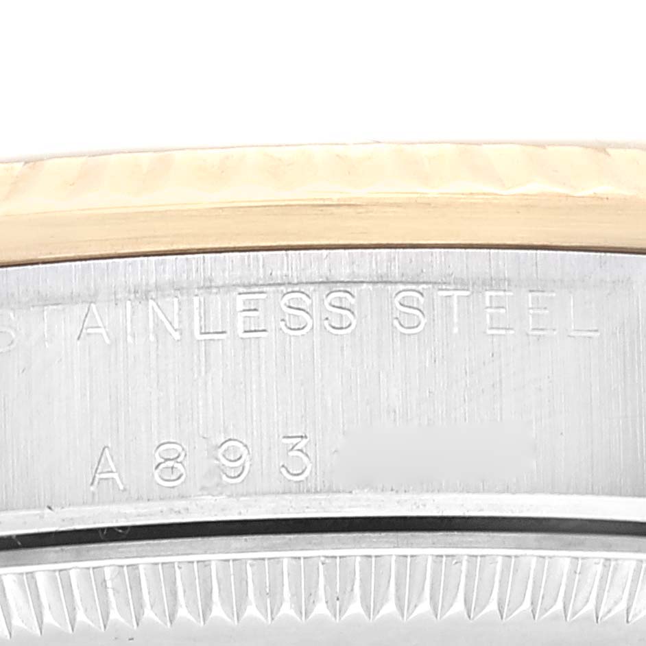This image shows a close-up of the side casing and edge of the bezel of a mid-size Rolex watch.