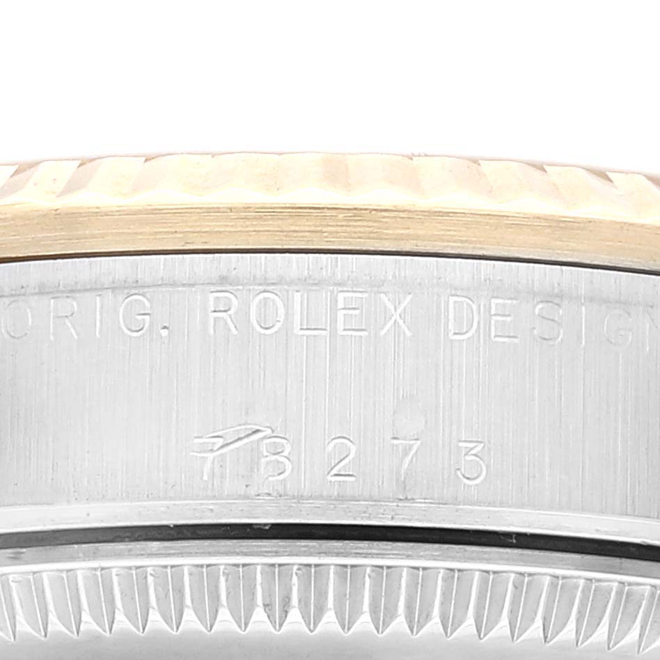 This close-up image shows the side engraving and fluted bezel of a Rolex Mid-Size 78273 Women
s Steel and Gold (two tone) Champagne Dial 78273 Women
s Steel and Gold (two tone) Champagne Dial model watch.