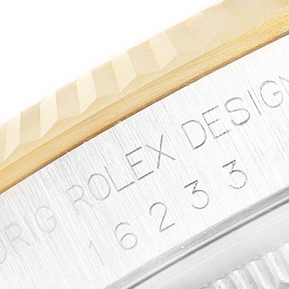The image shows a close-up of the Rolex Datejust 16233 Men
s Steel and Gold (two tone) Silver Dial 16233 Men
s Steel and Gold (two tone) Silver Dial watch
s fluted bezel and engraved case side, highlighting the model number "16233."