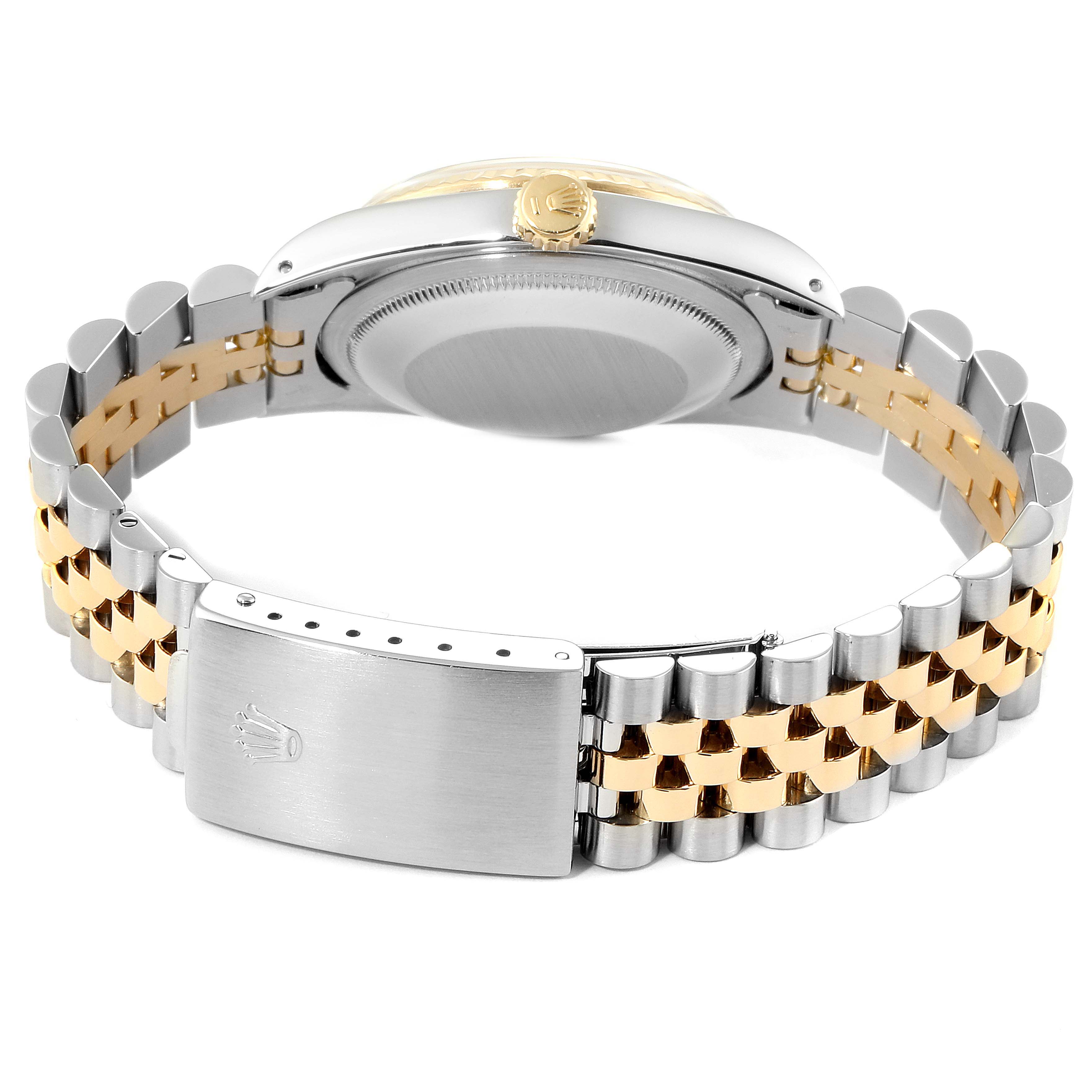 This image shows the back side and clasp of a Rolex Datejust 16233 Men
s Steel and Gold (two tone) Champagne Dial 16233 Men
s Steel and Gold (two tone) Champagne Dial watch, highlighting its two-tone bracelet.