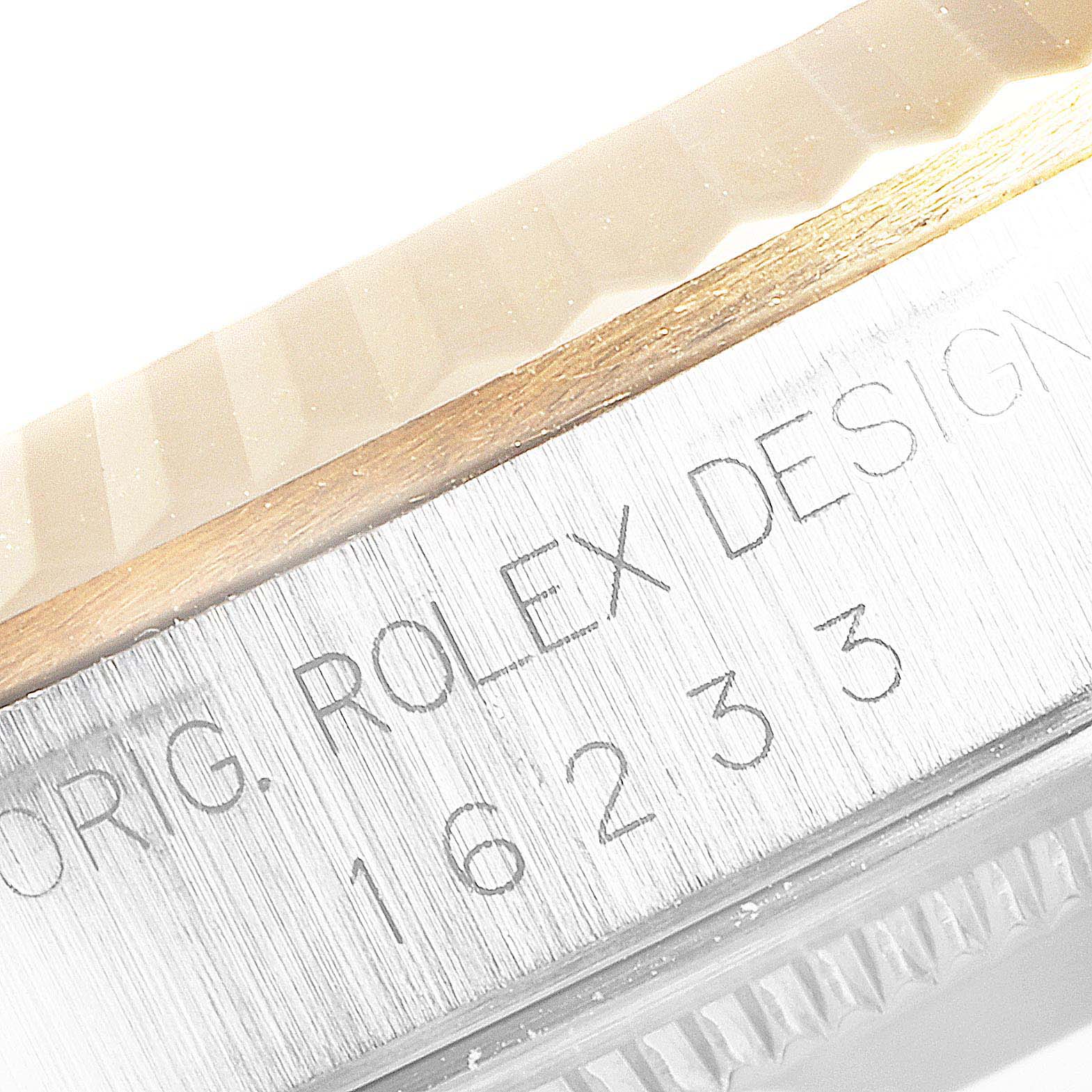 The image shows the side view of the casing of a Rolex Datejust 16233 Men
s Steel and Gold (two tone) Champagne Dial 16233 Men
s Steel and Gold (two tone) Champagne Dial model with engravings including the model number "16233".