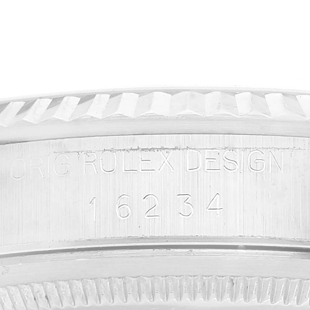 This close-up image shows part of the bezel and engraved serial number of a Rolex Datejust 16234 Men's Stainless Steel Black Dial 16234 Men's Stainless Steel Black Dial watch.