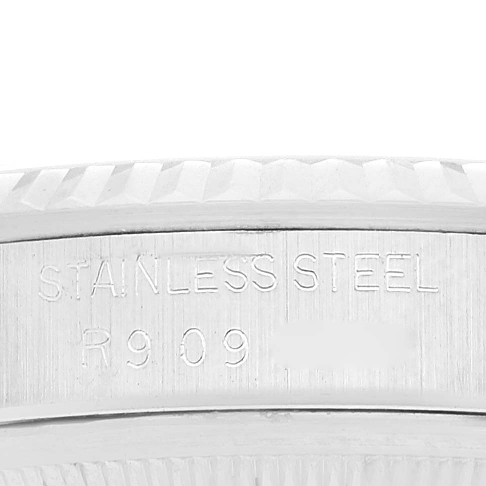 Close-up of the case side of a Rolex Datejust 16234 Men's Stainless Steel Black Dial 16234 Men's Stainless Steel Black Dial watch, showing the "STAINLESS STEEL" engraving and partial serial number.