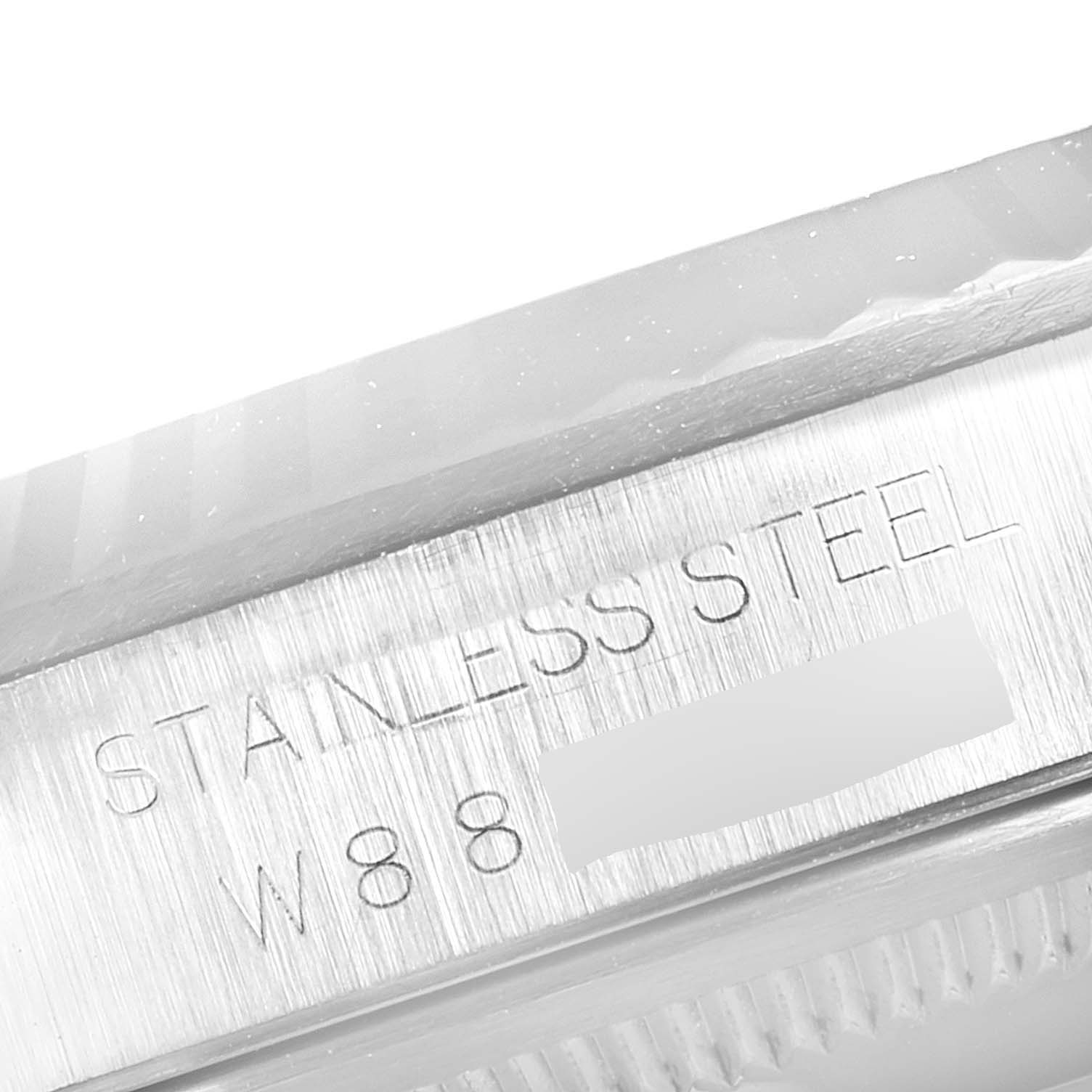 The image shows a close-up of the case side of the Rolex Datejust 16234 Men's Stainless Steel Pink Dial 16234 Men's Stainless Steel Pink Dial model, featuring stainless steel and part of the serial number.