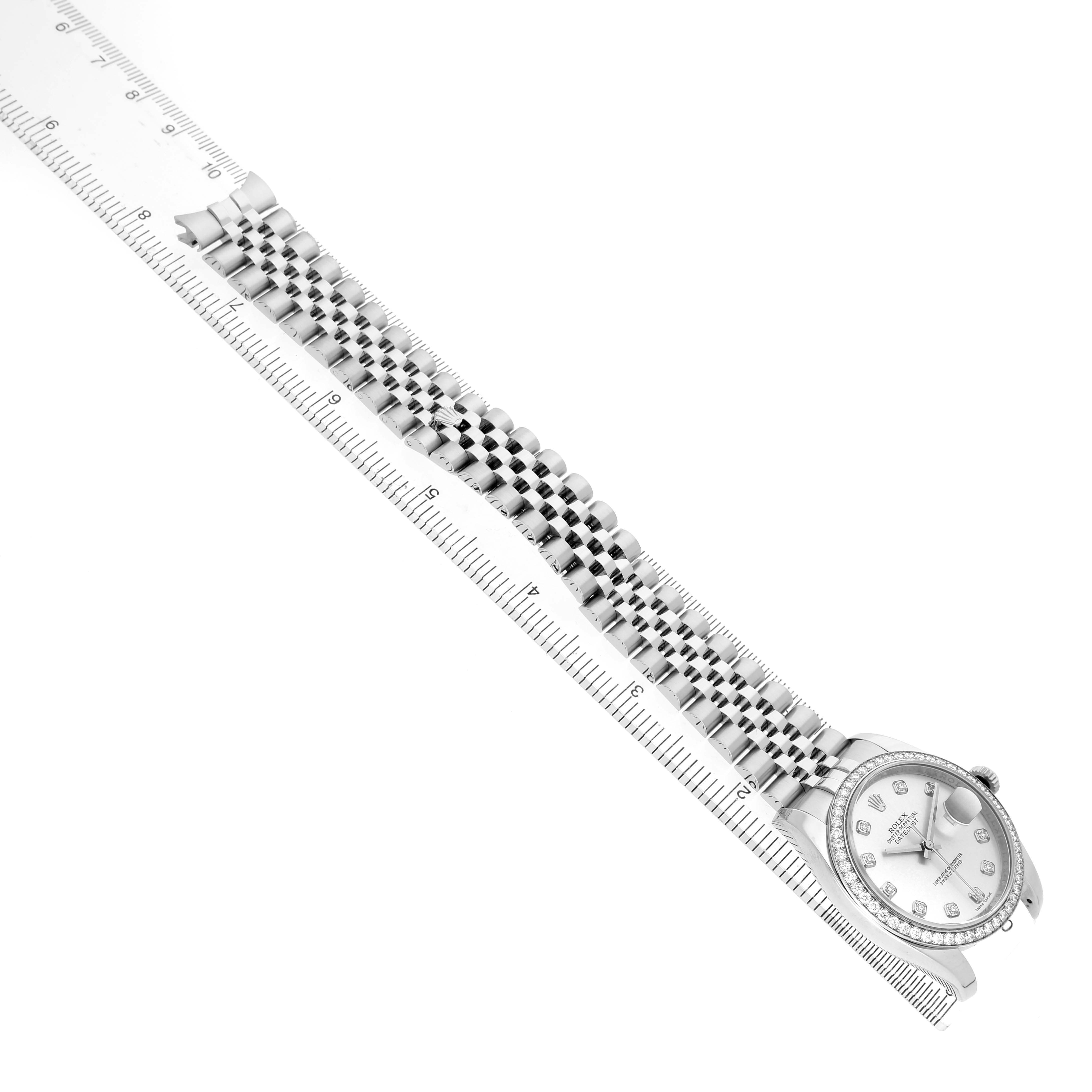 The Rolex Datejust 116244 Men's Stainless Steel Silver Dial watch is shown at an angle displaying the face, bezel, and full bracelet with a ruler for scale.