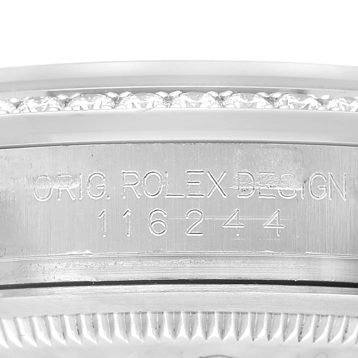 The image shows a close-up of the side engraving on the case of a Rolex Datejust 116244 Men's Stainless Steel Silver Dial watch.