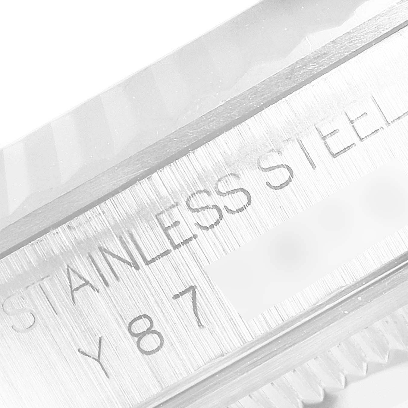 Close-up of the Rolex Datejust 16234 Men's Stainless Steel Silver Dial 16234 Men's Stainless Steel Silver Dial's stainless steel case showing inscription detail.