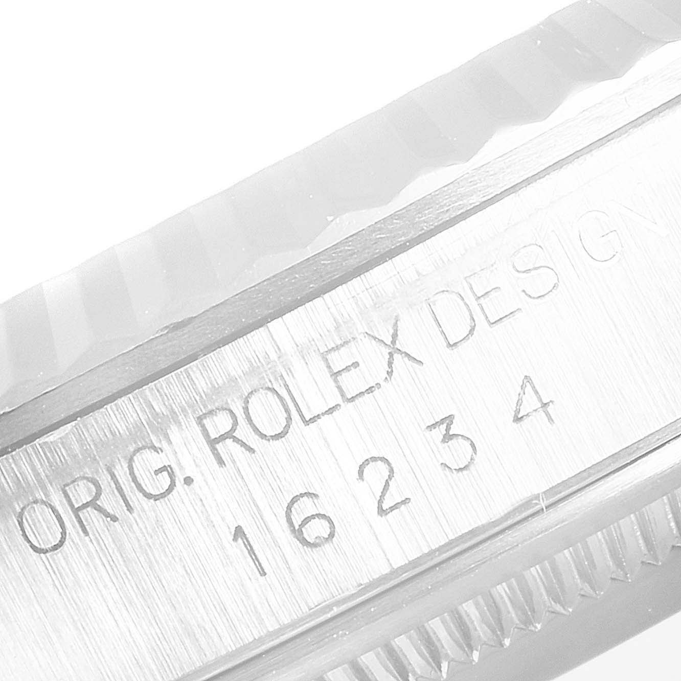 The image shows a close-up of the case side of a Rolex Datejust 16234 Men's Stainless Steel Silver Dial 16234 Men's Stainless Steel Silver Dial watch, featuring the model number 16234 and "ORIG. ROLEX DESIGN" engraving.