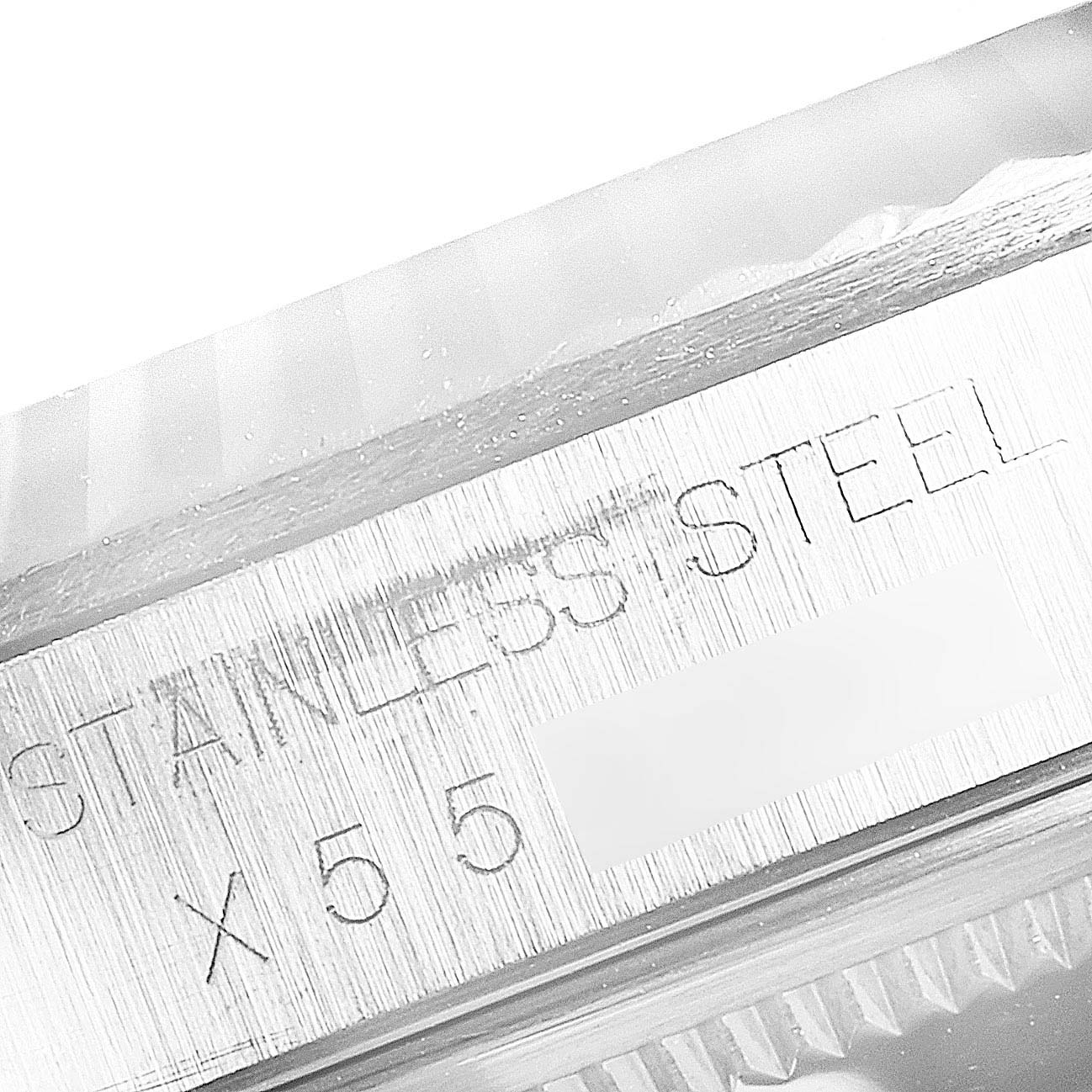 This image shows a close-up of the stainless steel engraved part of the Rolex Datejust 16234 Men's Stainless Steel Silver Dial 16234 Men's Stainless Steel Silver Dial watch case.