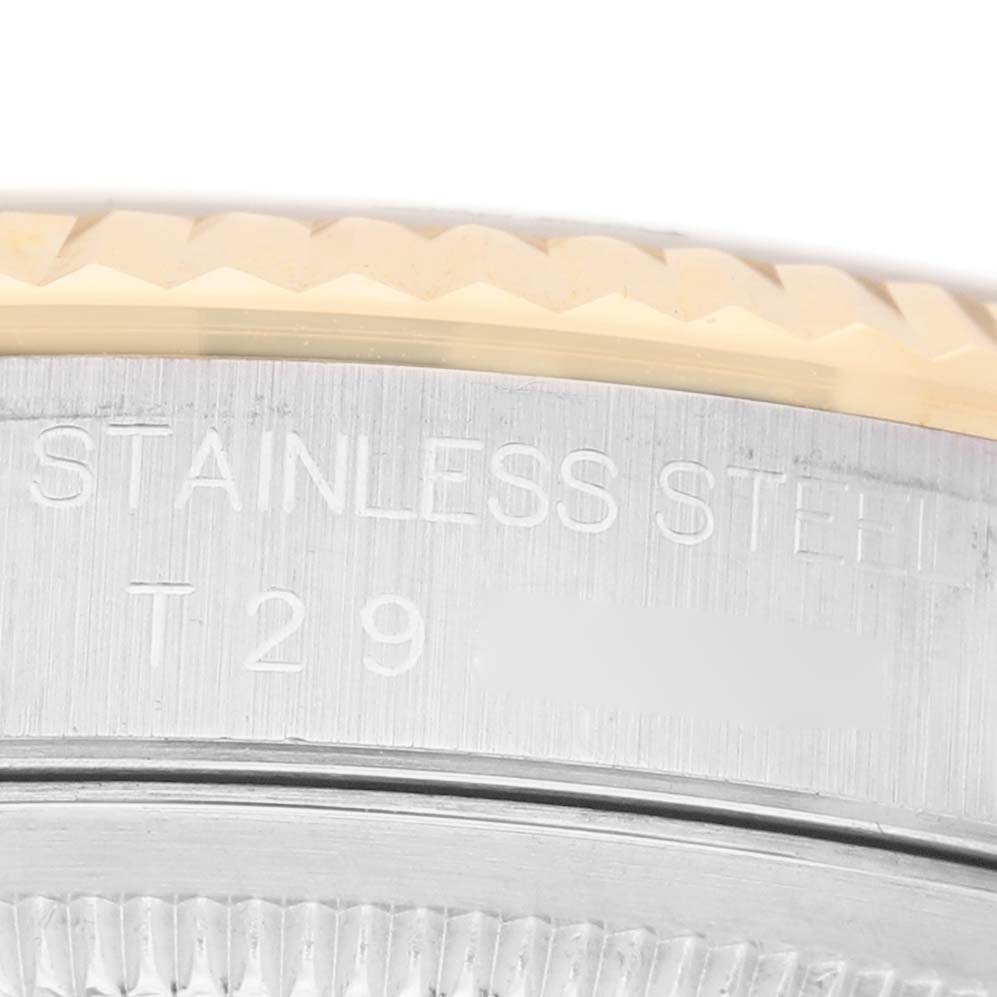 The image shows a close-up of the side of a Rolex Datejust 16233 Women's Steel and Gold (two tone) Silver Dial, highlighting the engraved stainless steel part.