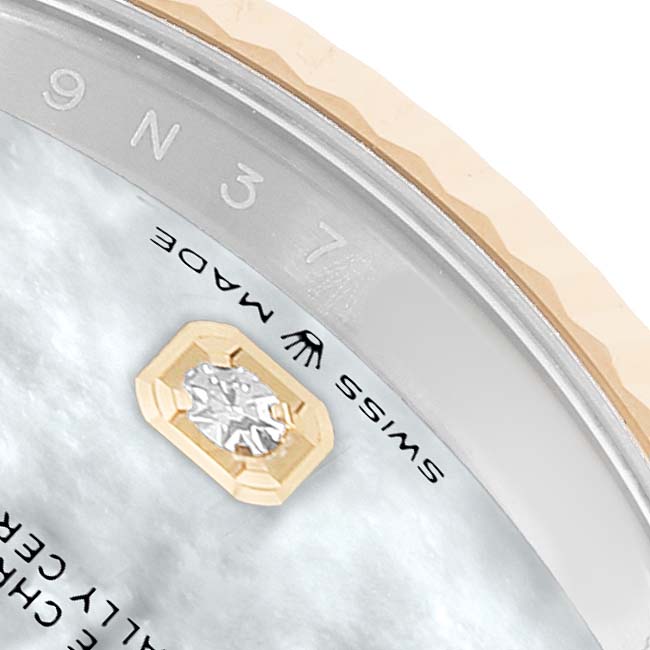 The image shows a close-up of the Rolex Datejust 126233 Men's Steel and Gold (two tone) Mother of Pearl Dial's bezel edge and part of the dial with a diamond detail.