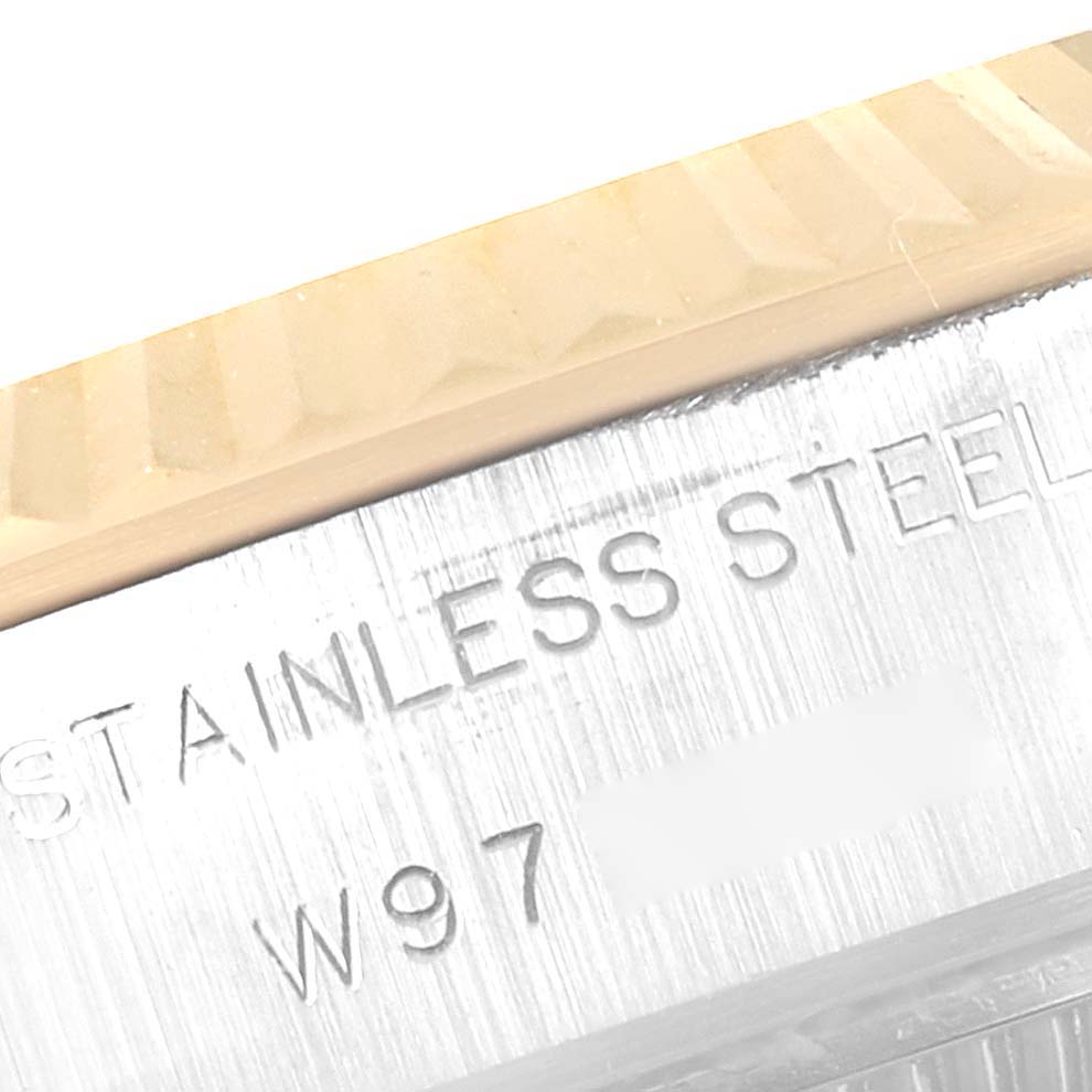 The image shows a close-up of the case and bezel of a Rolex Datejust 69173 Women
s Steel and Gold (two tone) Grey Dial 69173 Women
s Steel and Gold (two tone) Grey Dial watch, highlighting the "STAINLESS STEEL" engraving.